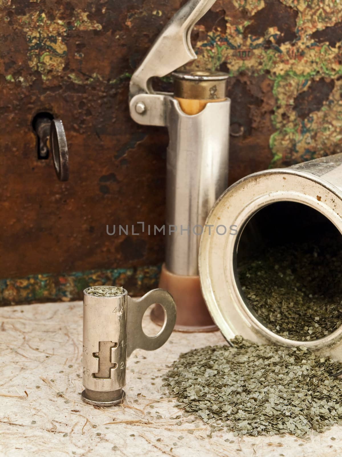 Photo of gunpowder and hunting accessories and old chest at beige 