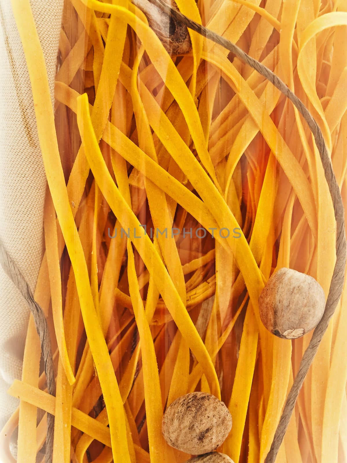 chili pasta decorated with nutmegs and cord under glass
