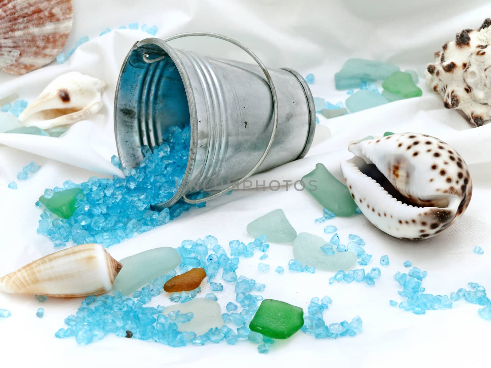 marine decor with sea shells, bucket and decorative stones at white