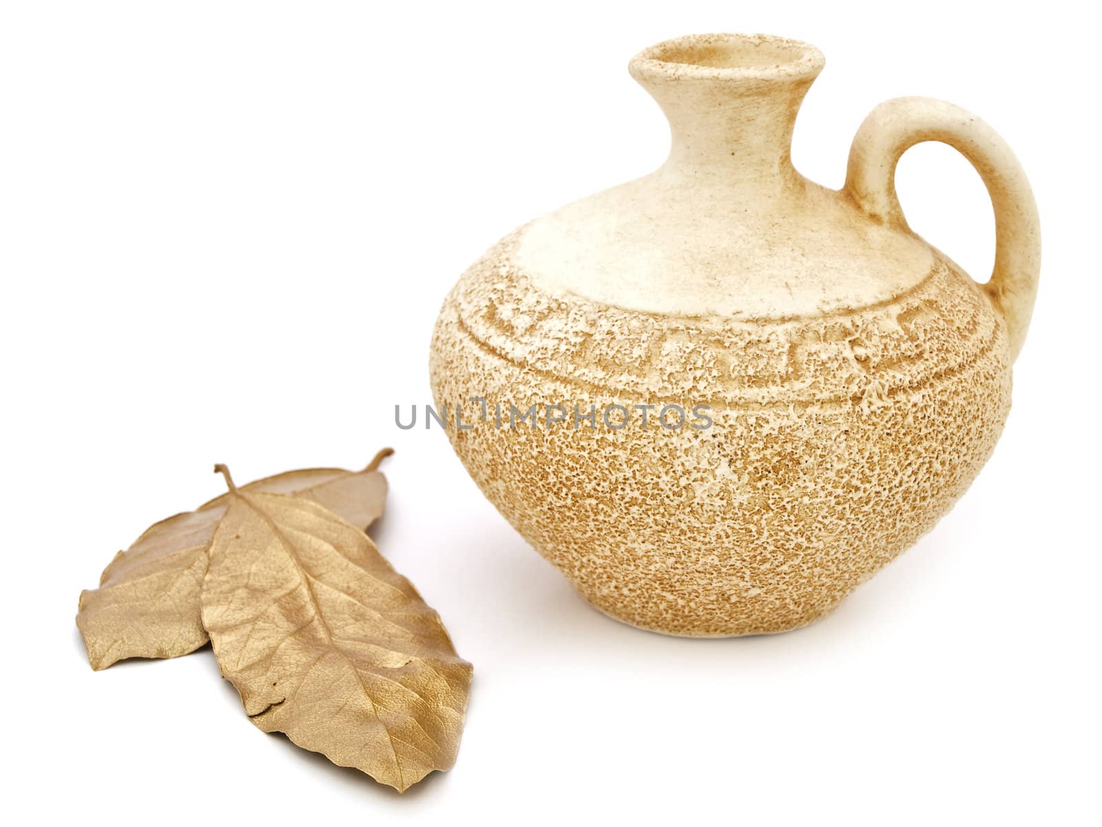 ancient beige vase and golden bay leaves against white background