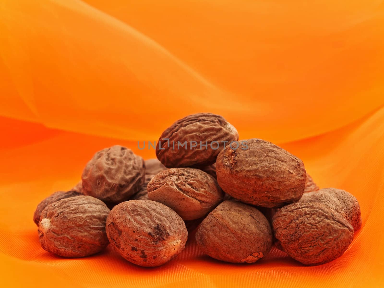 Photo of nutmeg stack at orange textile