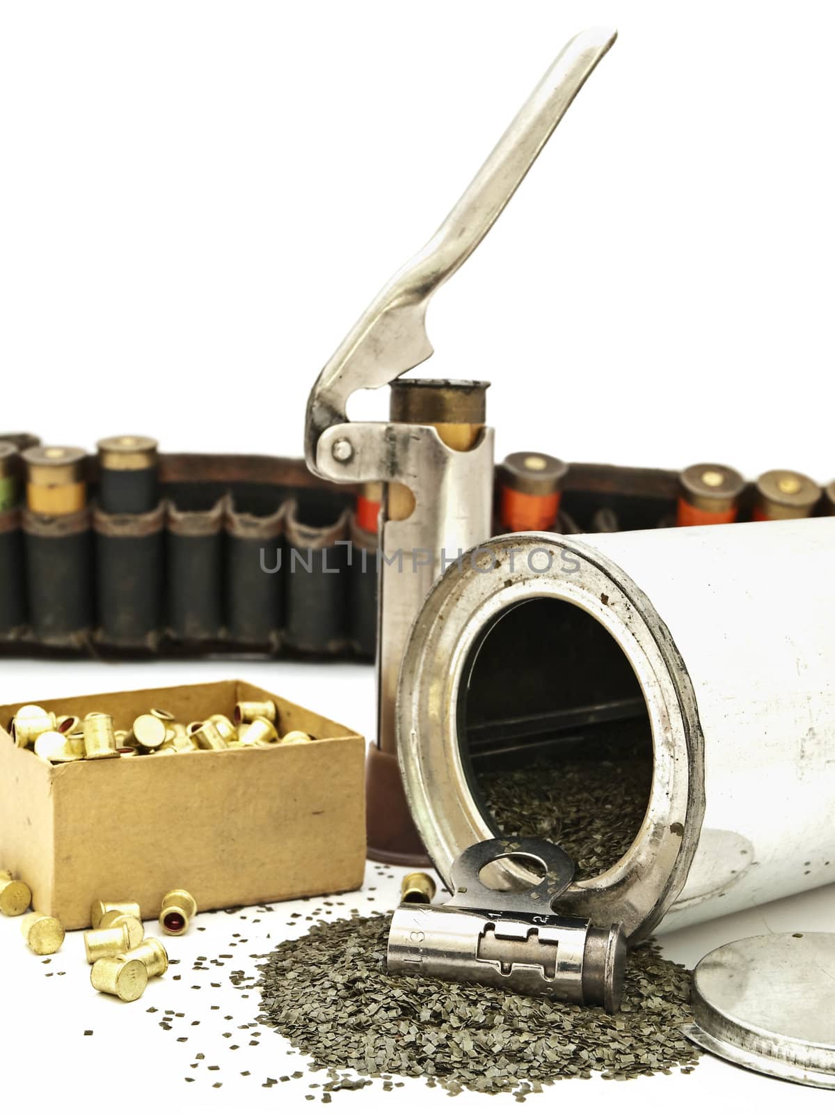 scattered gunpowder and hunting accessories against of old cartridge for hunting rifle