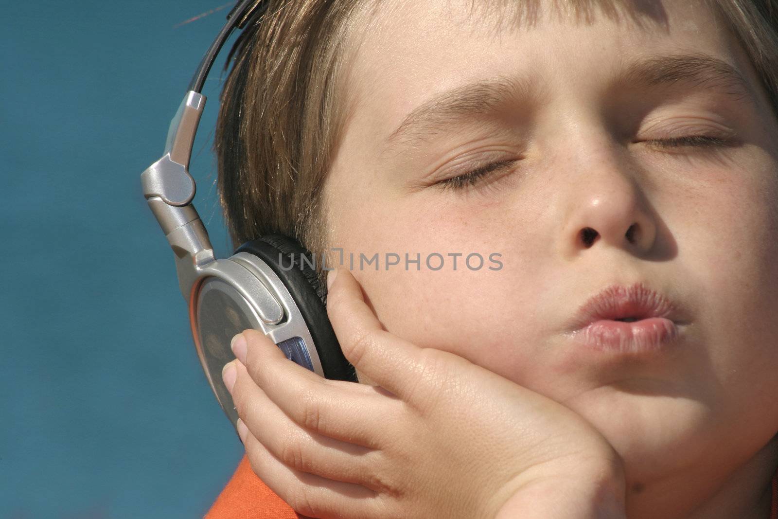 A closeup of a child whistling to a tune.