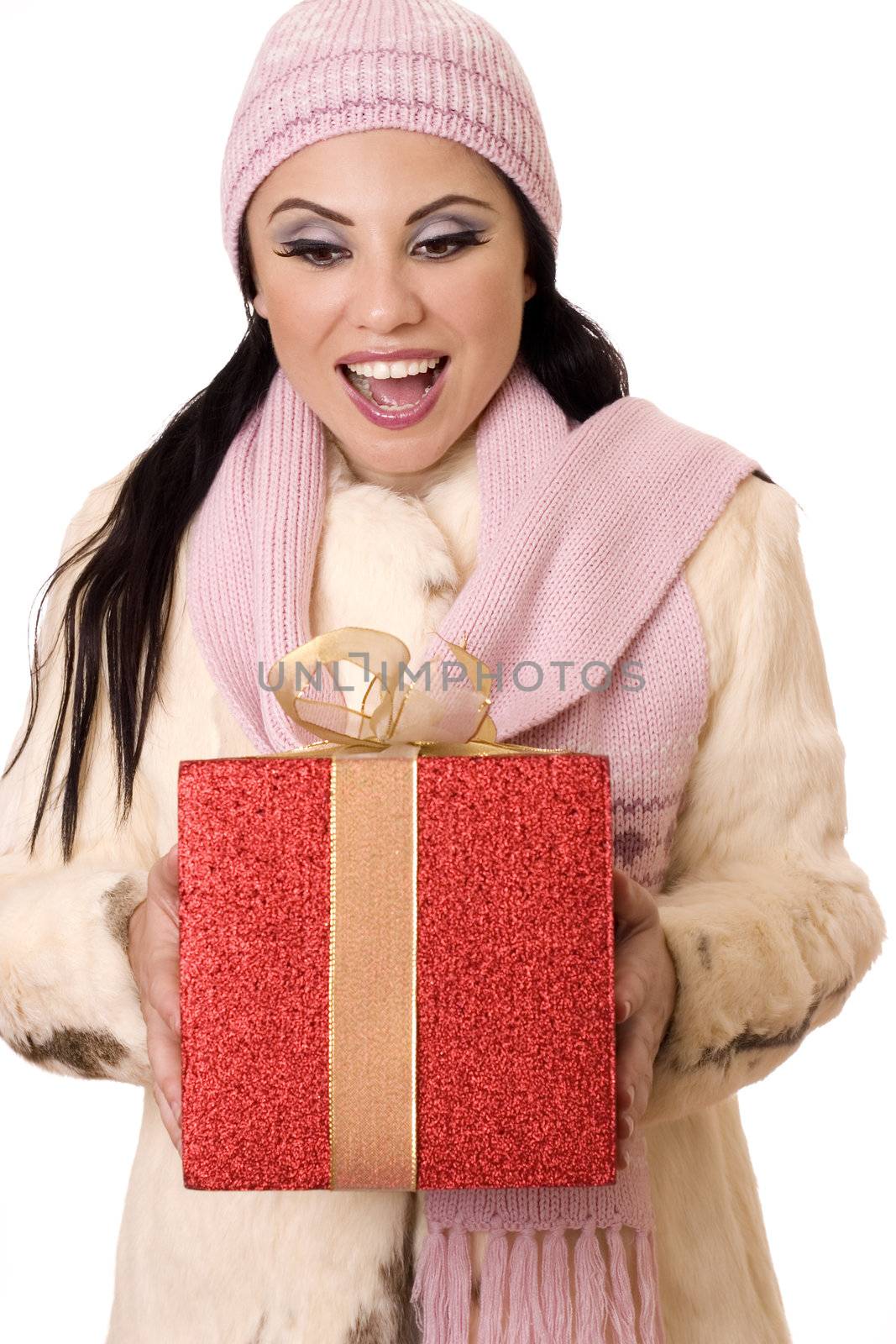 Beautiful brunette holding a large red box tied with gold gauze ribbon with a gleeful,  surprised expression.
