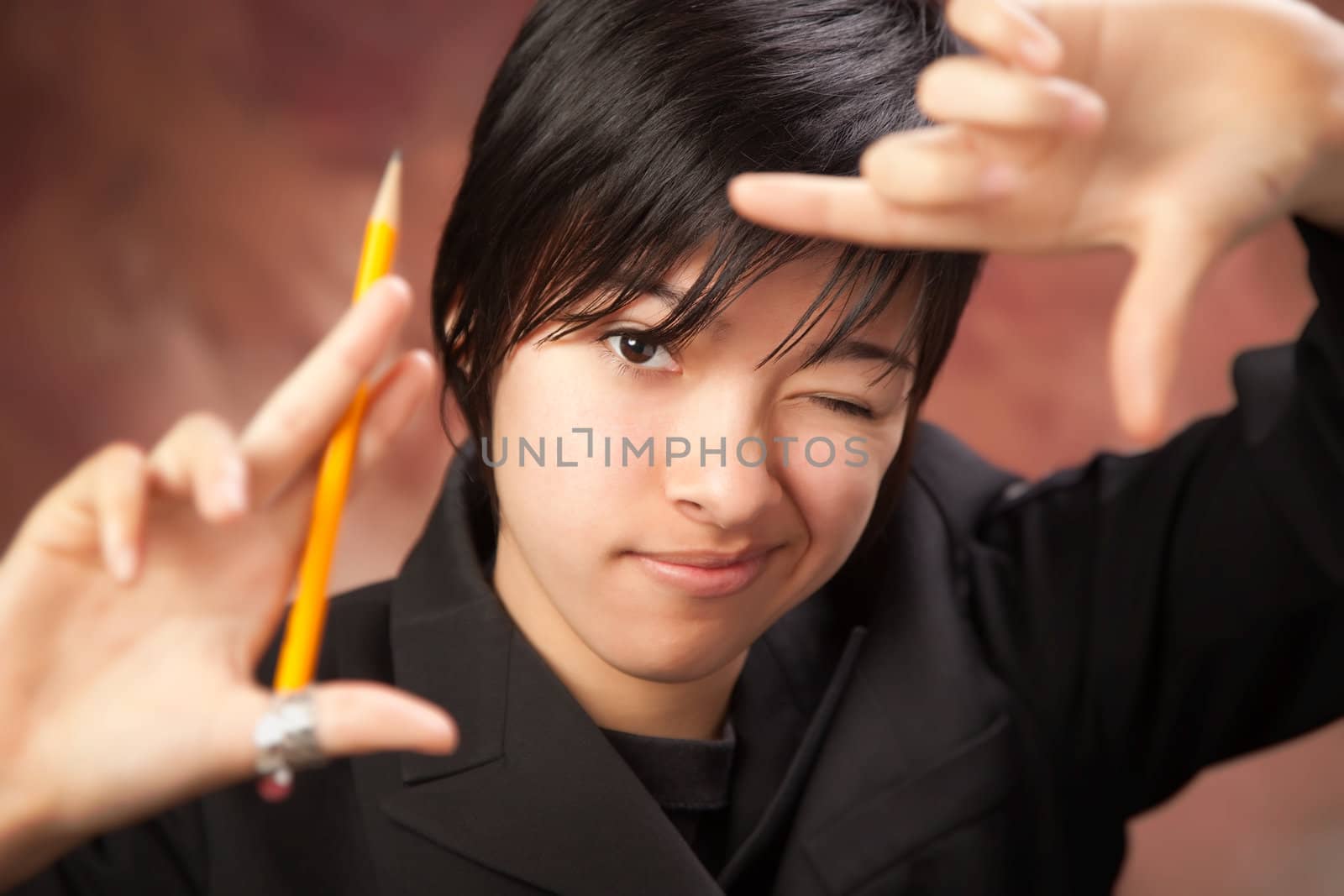 Pretty Multiethnic Girl Poses for Her Portrait Making a Frame with Hands.