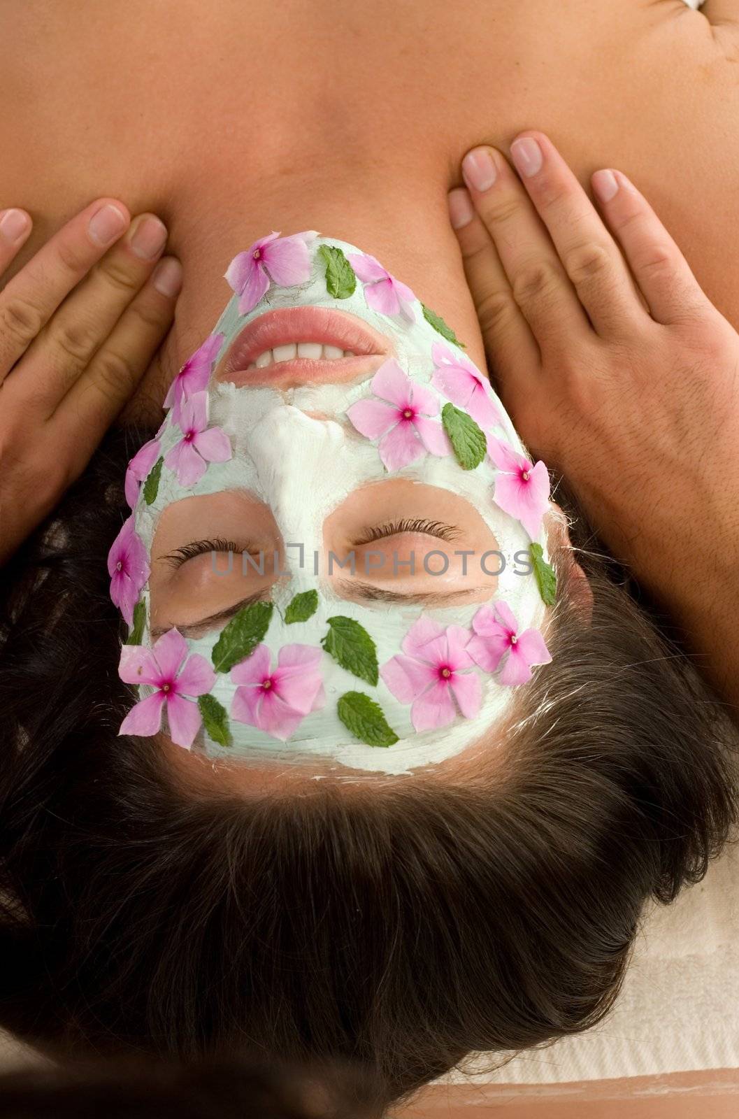 A woman enjoys a salon mask and massage