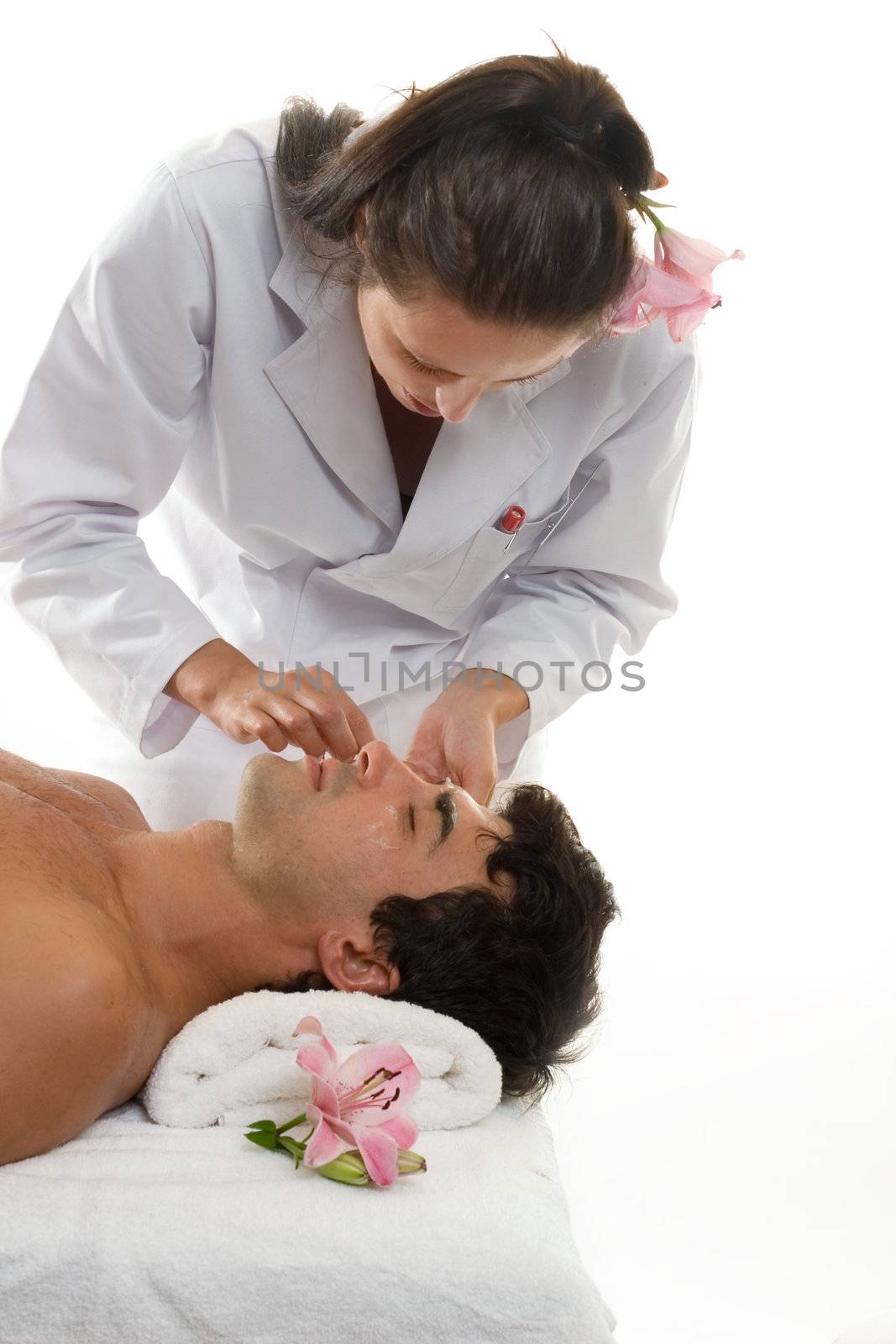 Beatician or esthetician treating a male client