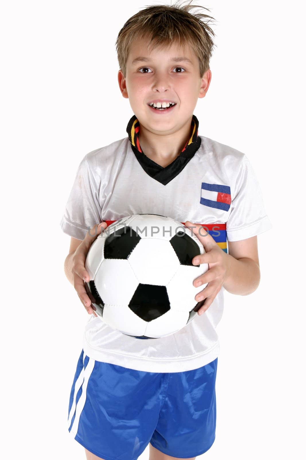 A happy child holding a soccer ball.