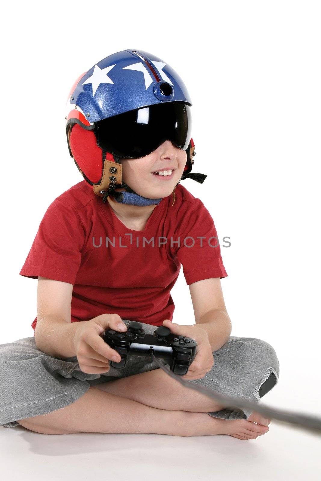 Child wearing a helicopter pilot helmet with visor happily plays a flight simulator computer game.