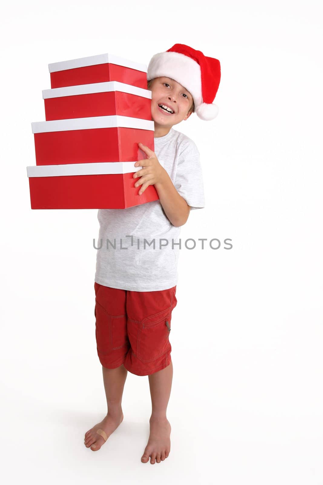 Boy carrying red and white gift boxes