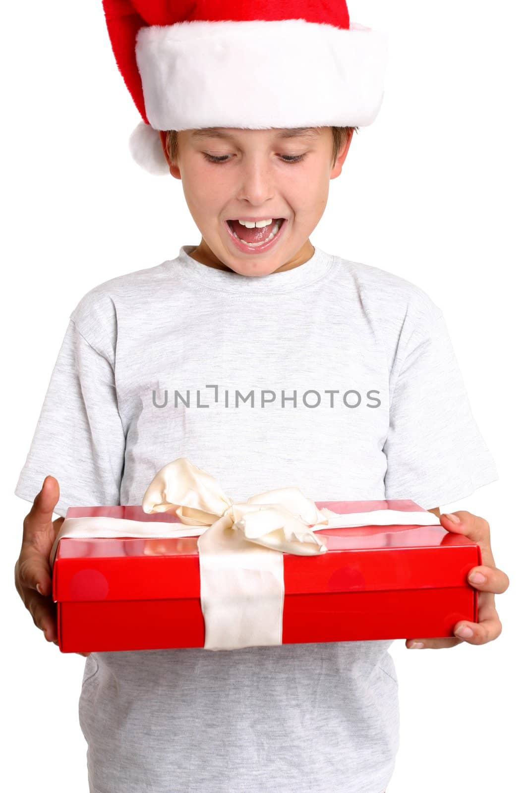 A delighted child holding a wrapped Christmas present.