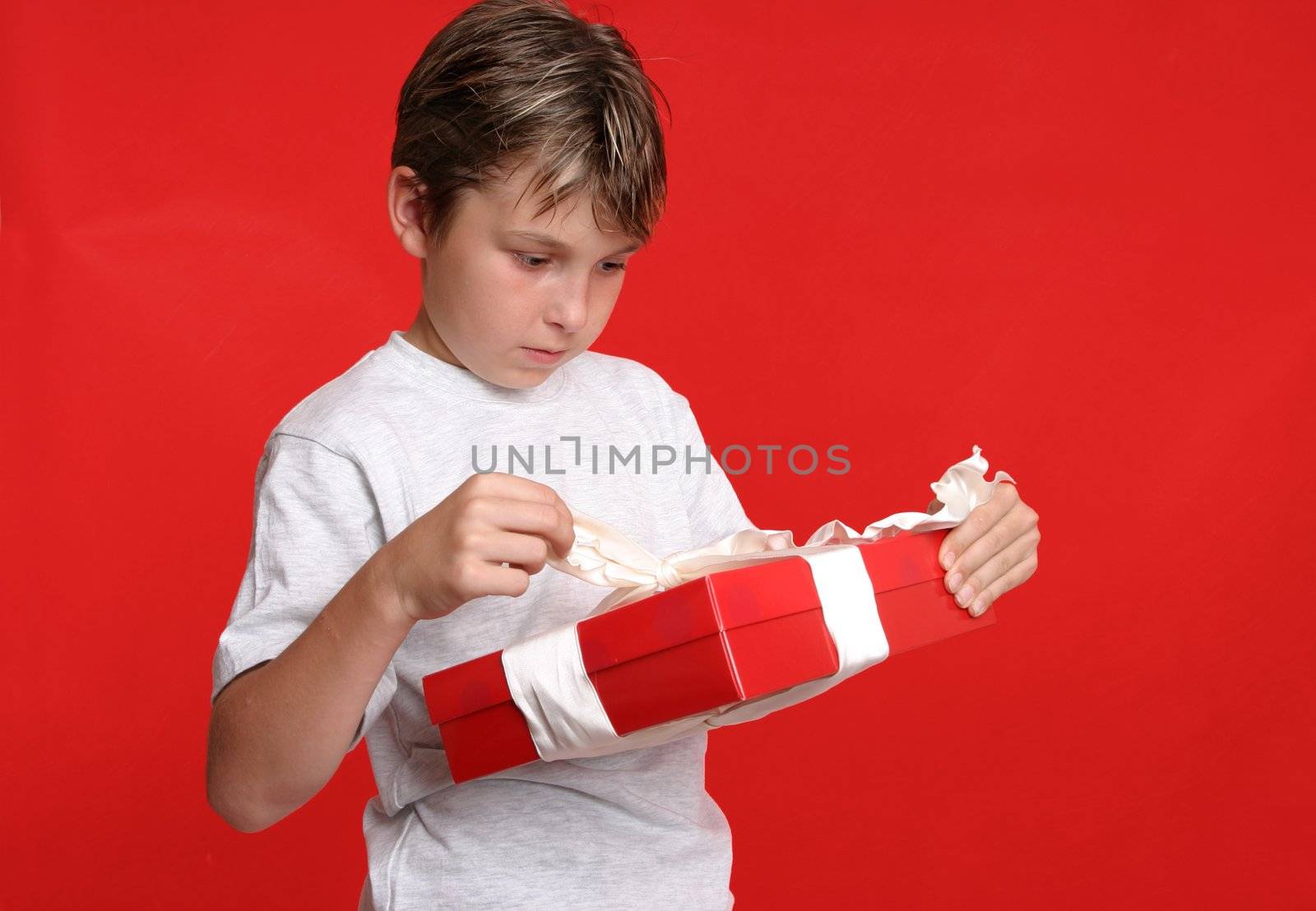 A child unwraps a birthday or Christmas present.