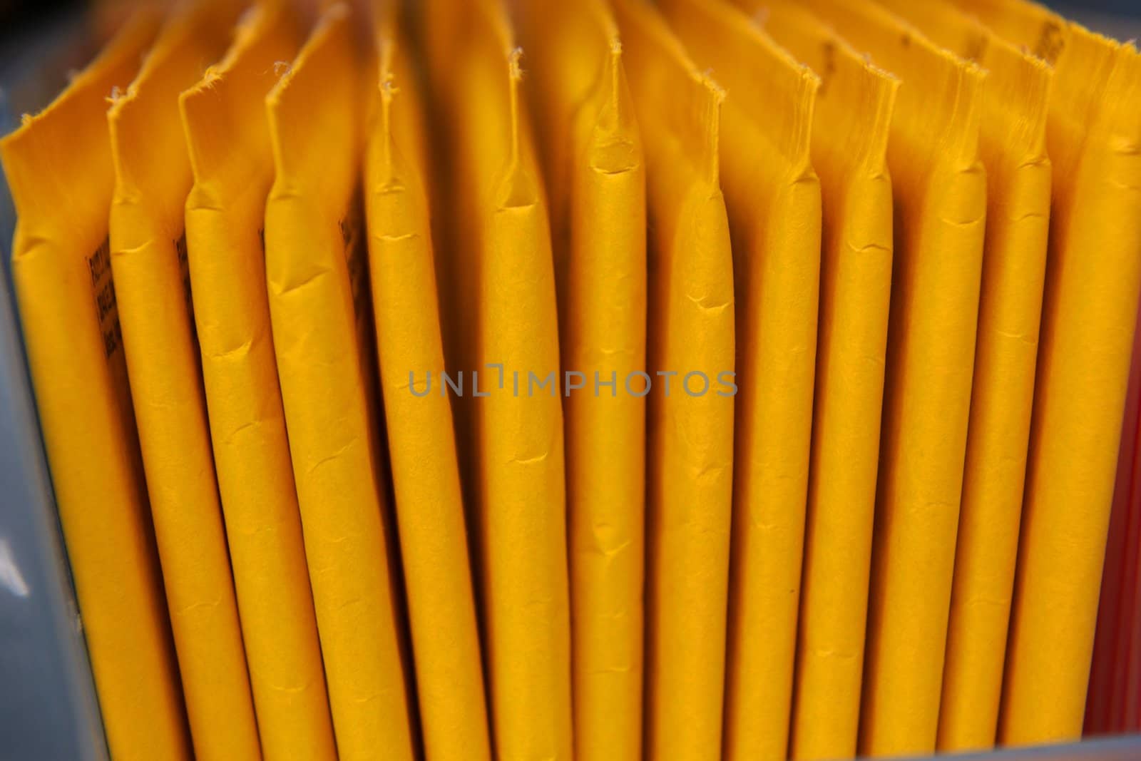 Yellow Stuffed Envelopes in a Row by pixelsnap