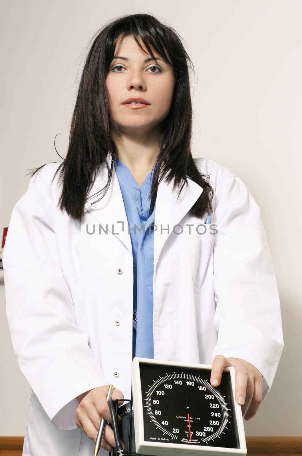 Low angle shot of a hospital worker in a typical uniform and coat.