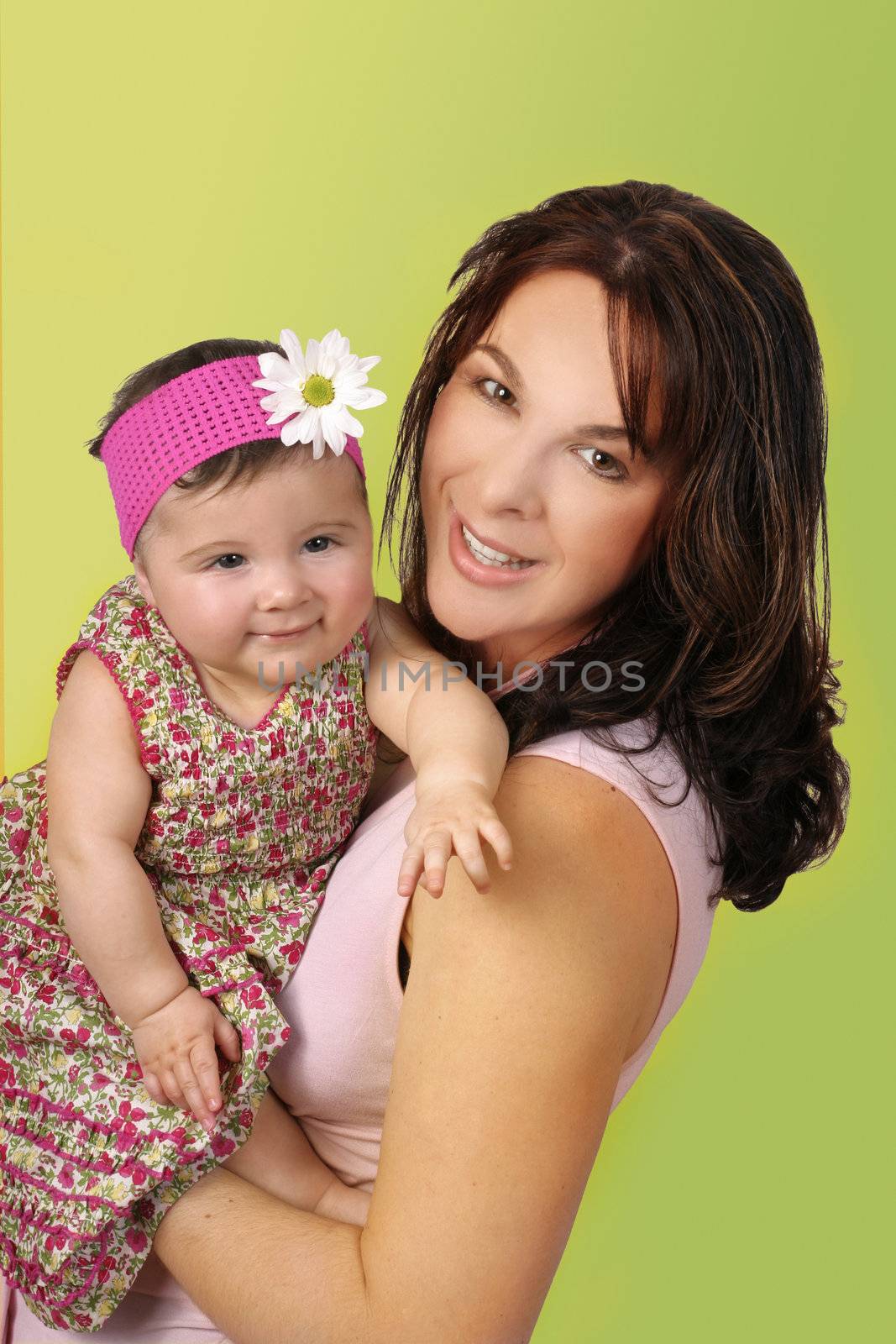 Young mother holding her attentive baby girl