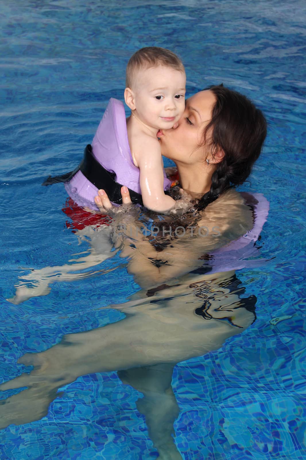 Mum with the son bathe in pool