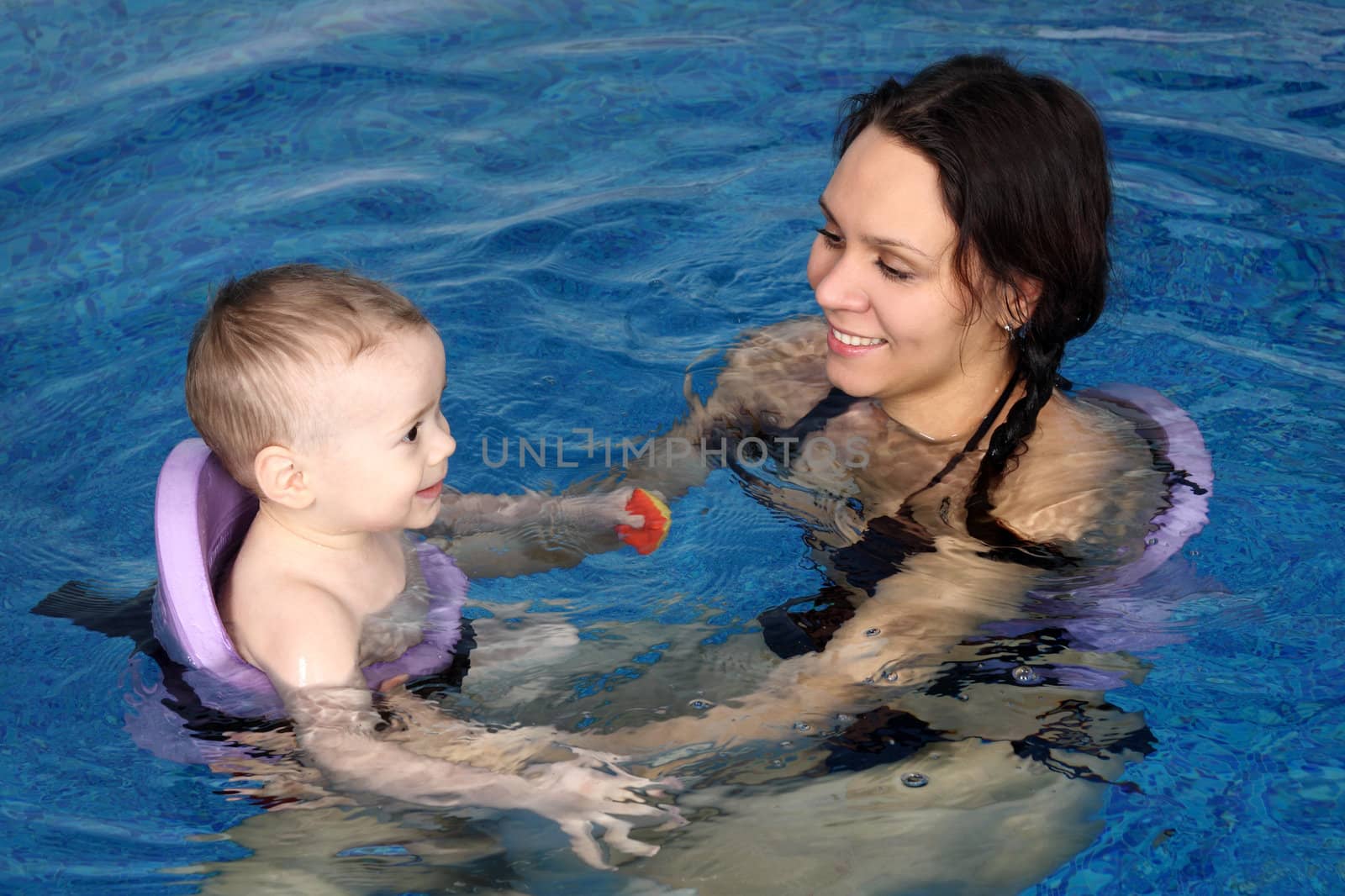 Mum with the son bathe in pool