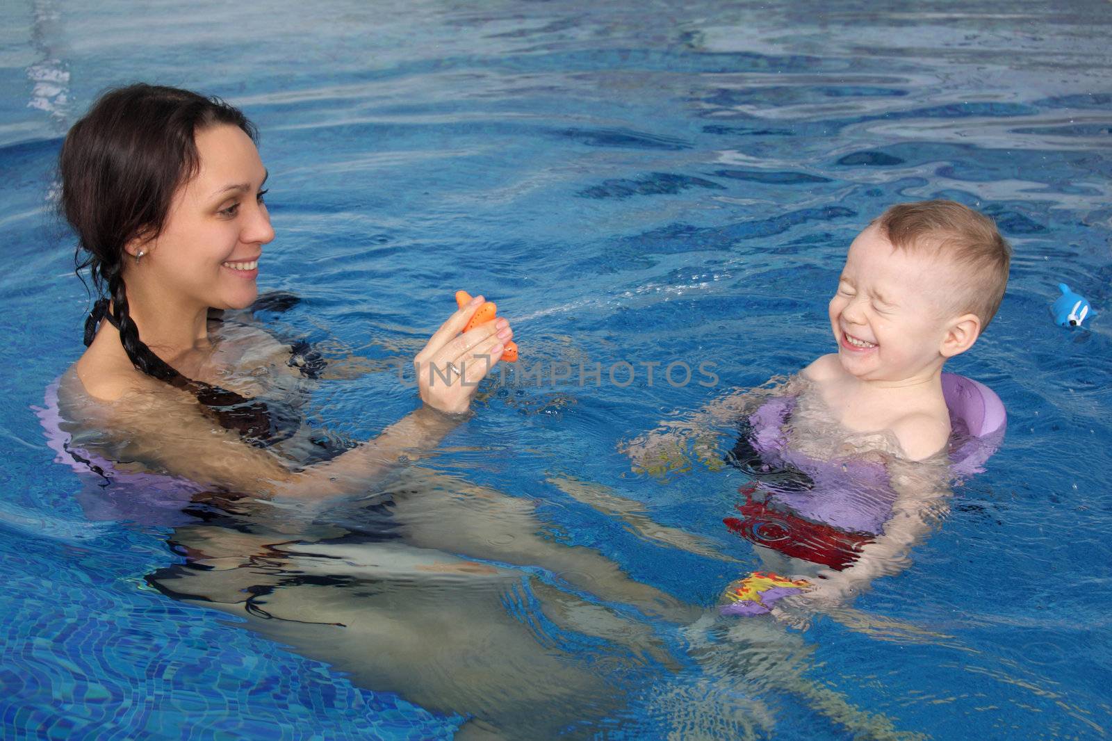 Mum with the son bathe in pool