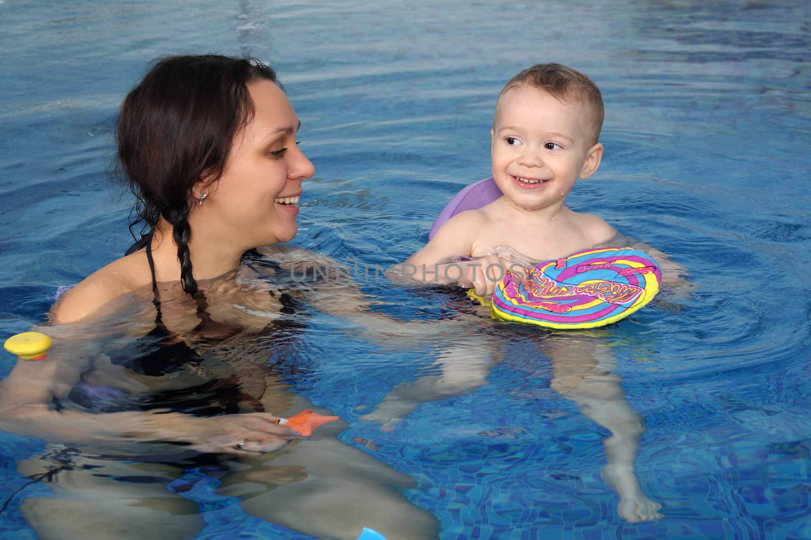 Mum with the son bathe in pool