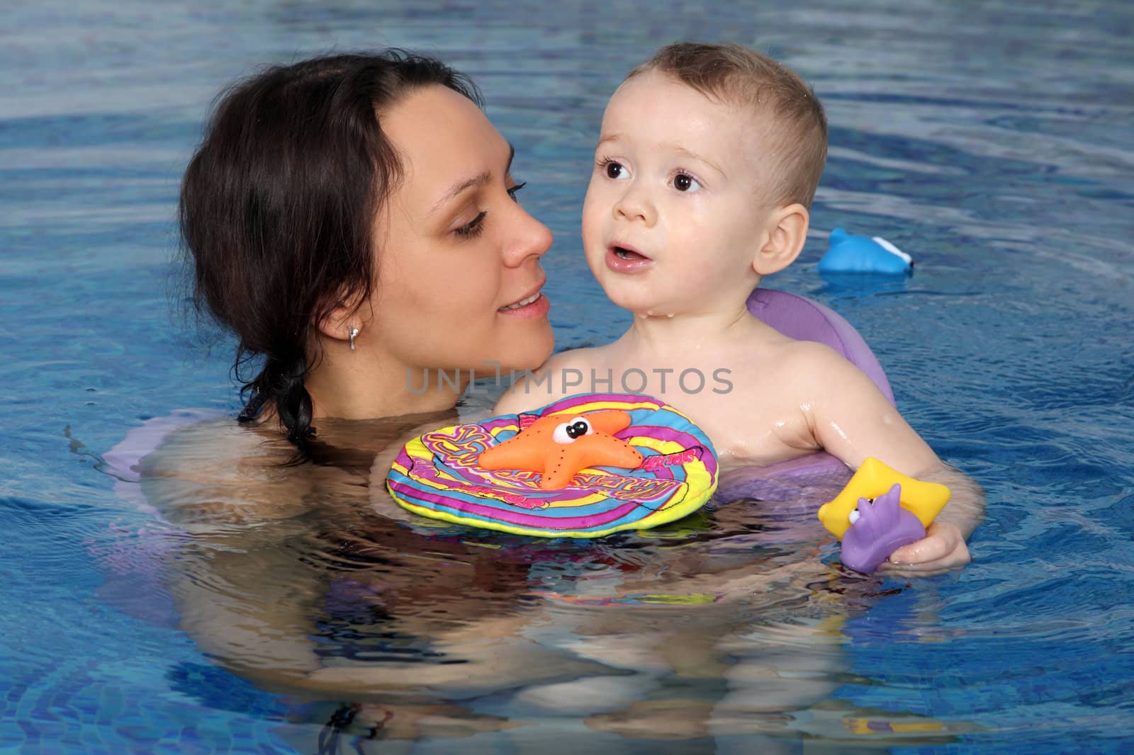 Mum with the son bathe in pool