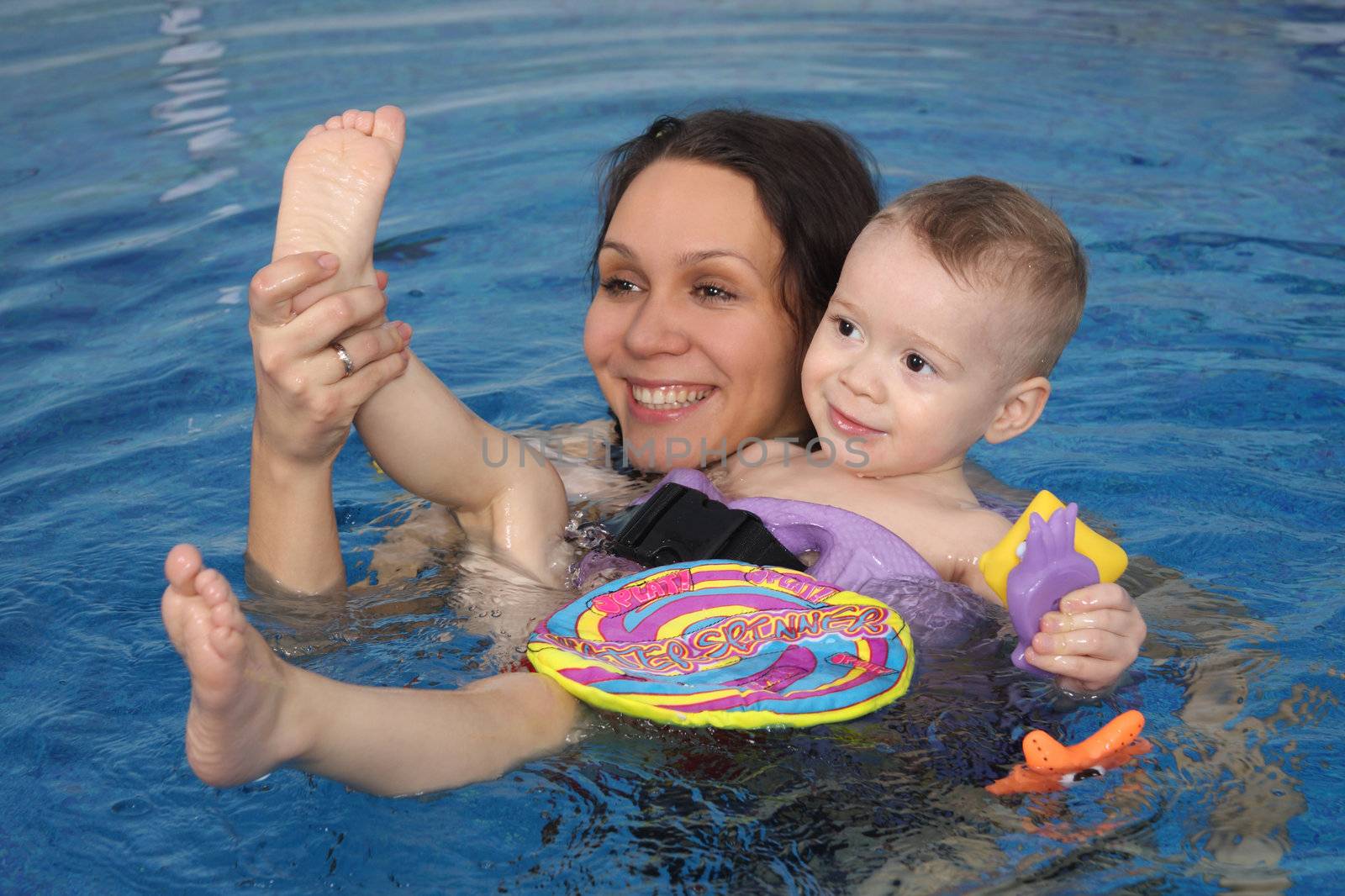 Mum with the son bathe in pool