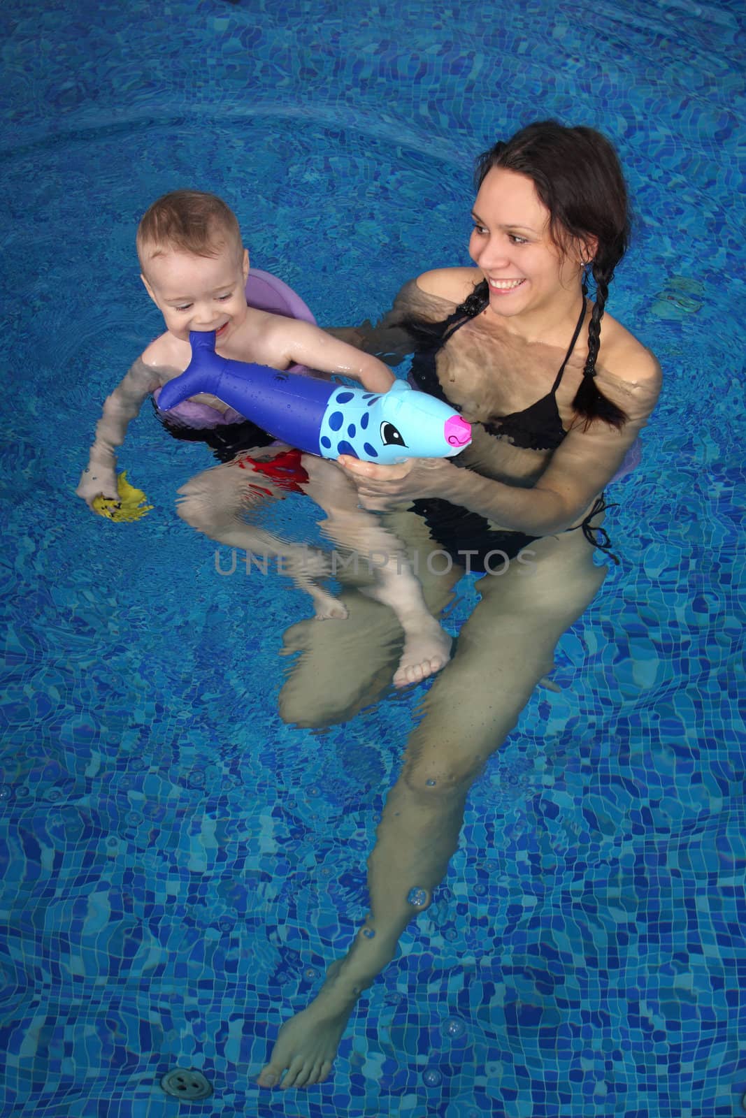 Mum with the son bathe in pool