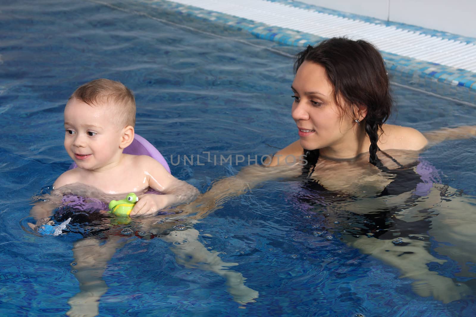 Mum with the son bathe in pool