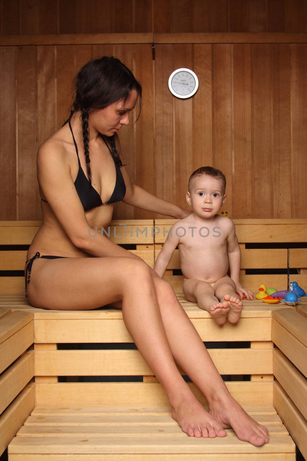 Mum with the small son are heated in a sauna
