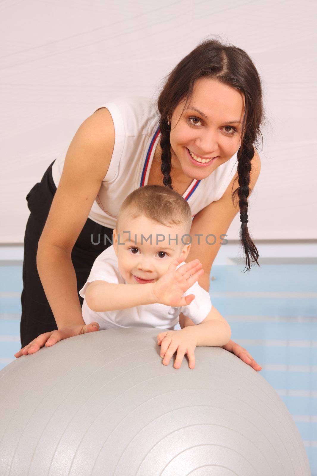 Mum with the son play a sports hall
