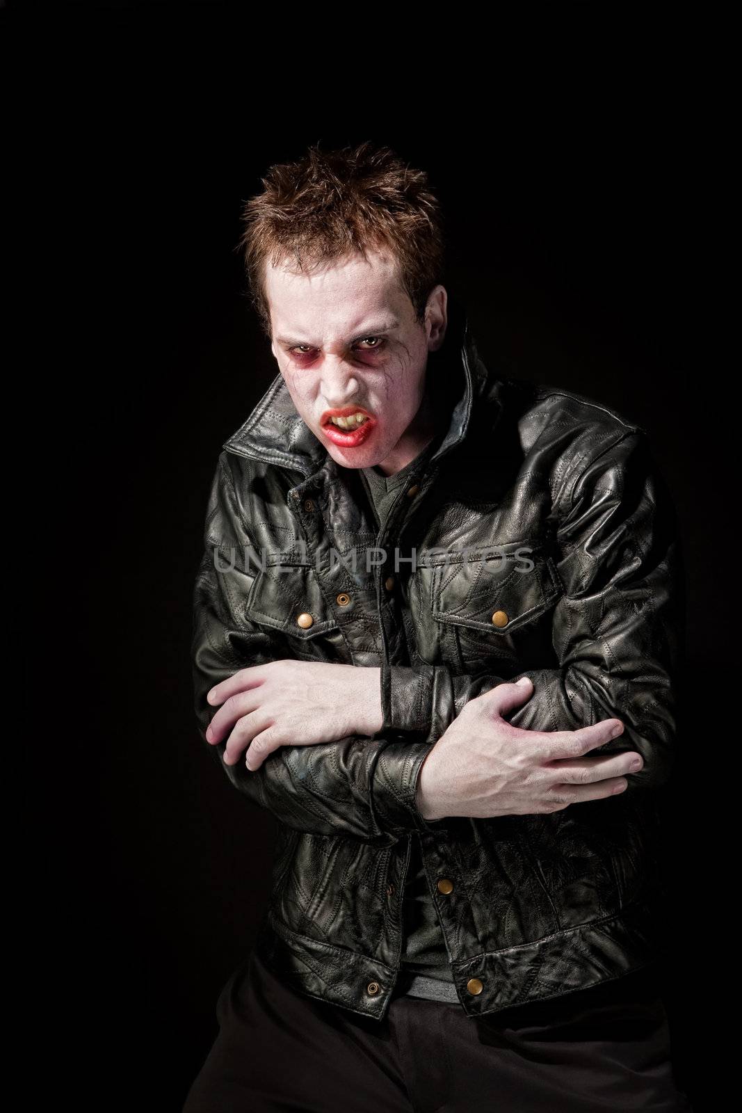 Angry young male zombie in black leather jacket