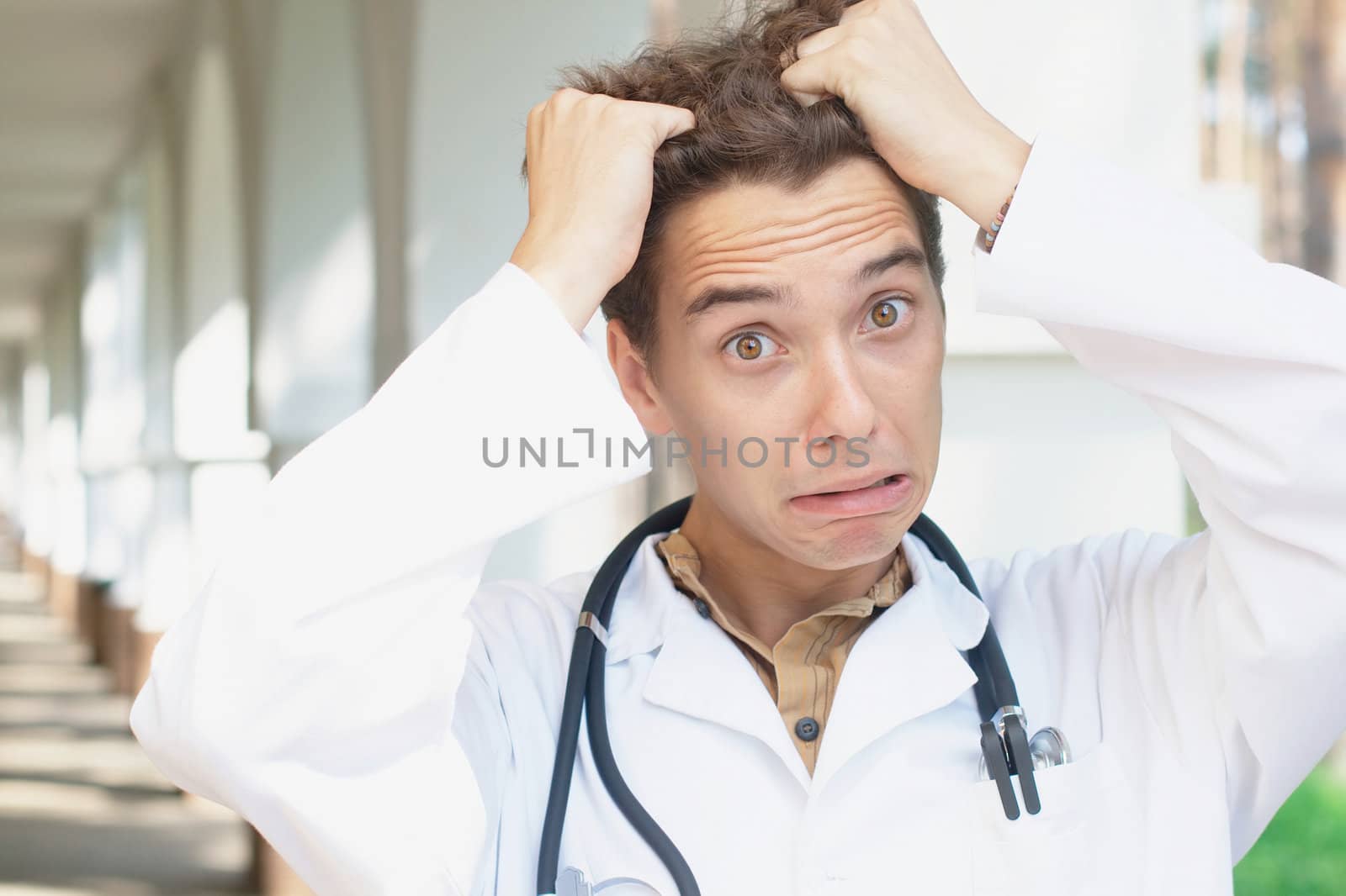Close up portrait of a shocked young doctor