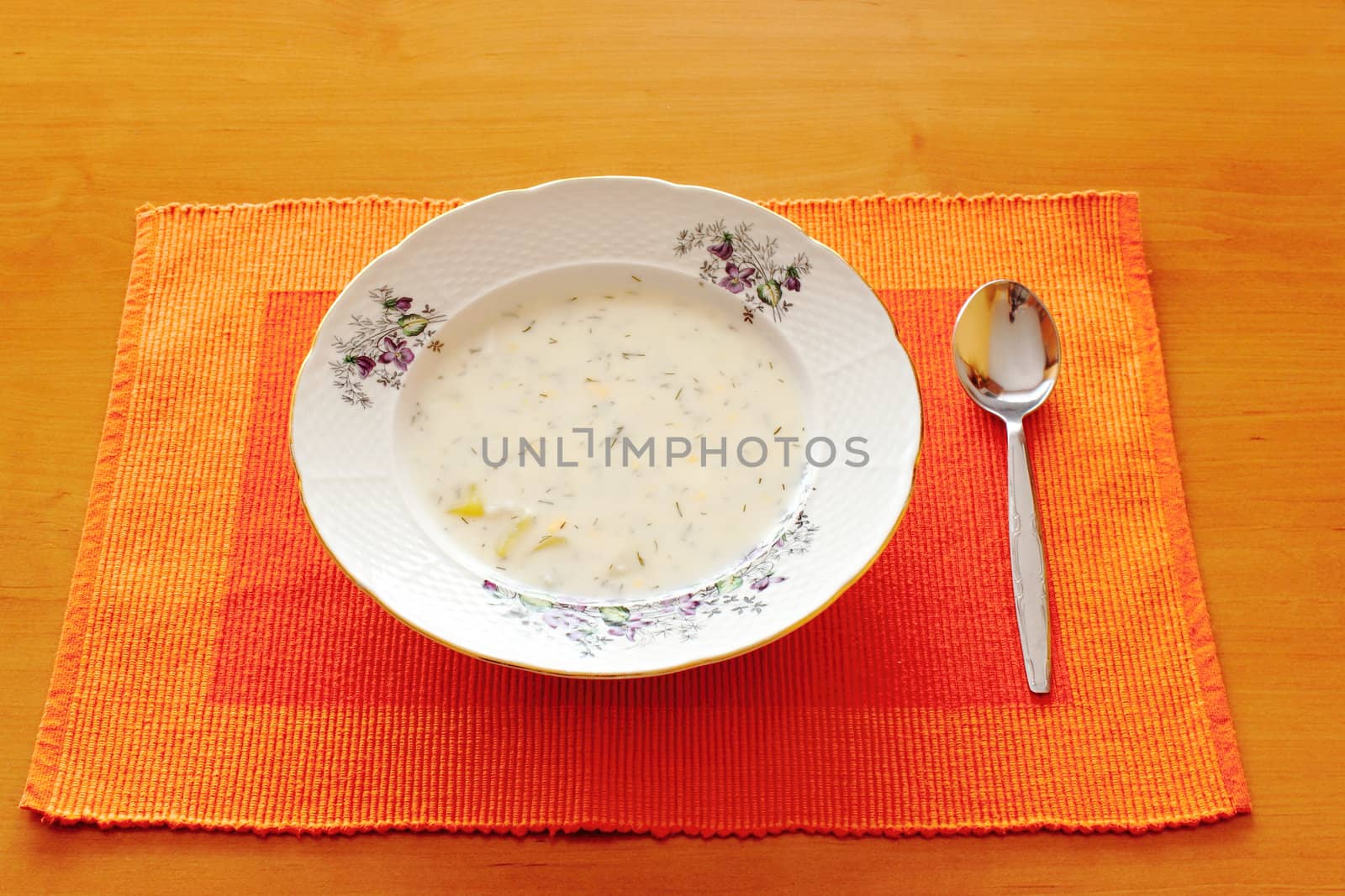czech white milk and dill soup with table spoon