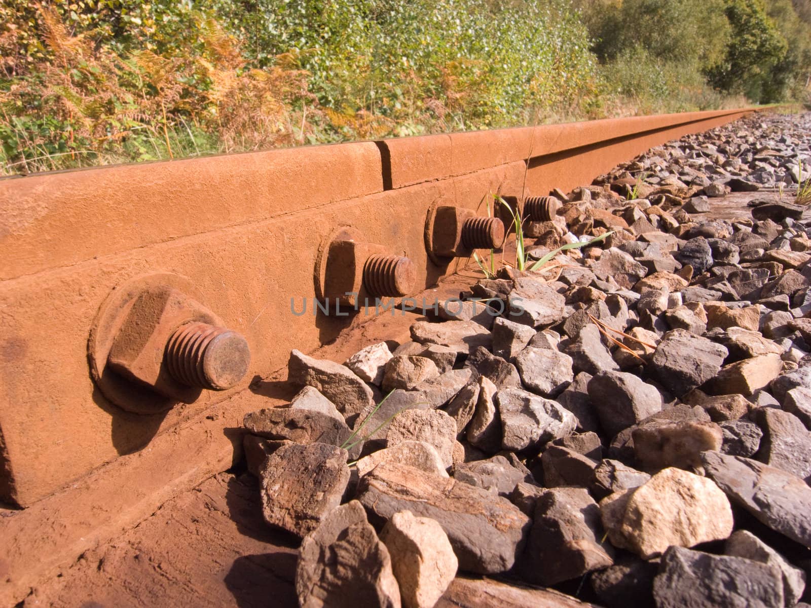 Nuts, bolts and bracket joining two lines on a railway.