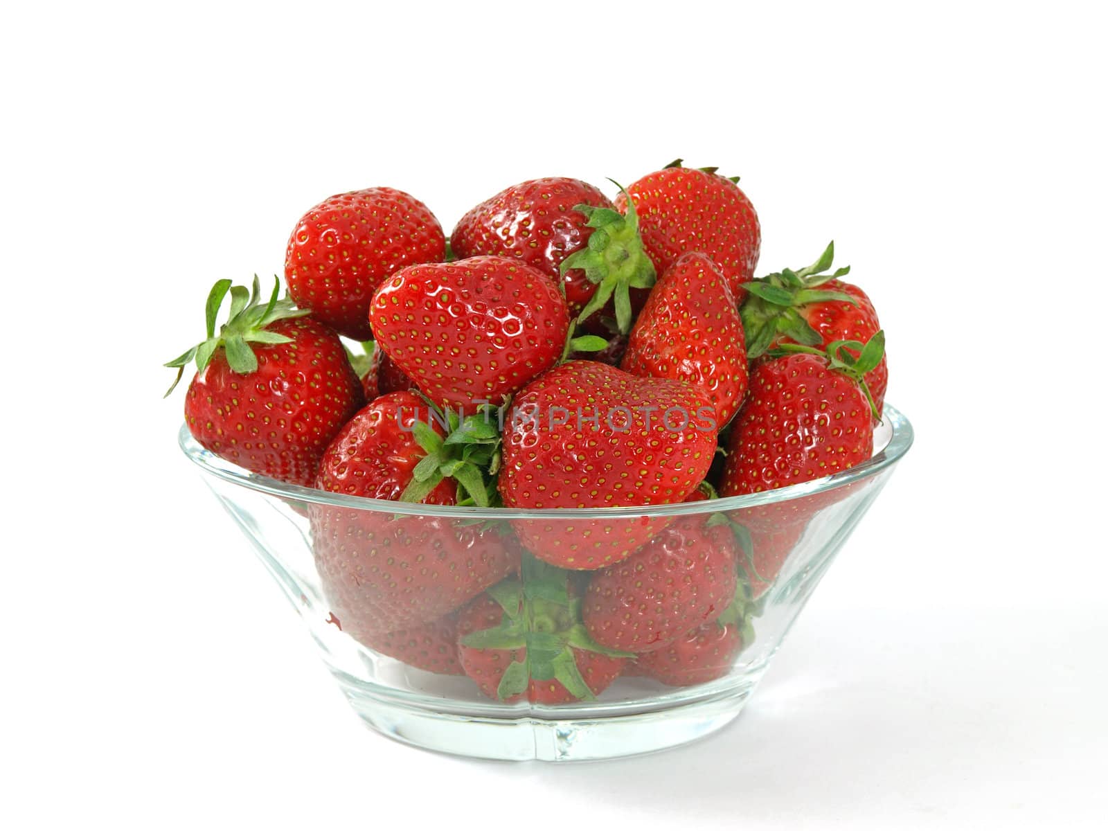 fresh and juicy strawberries on glass bowl over white  by Ric510