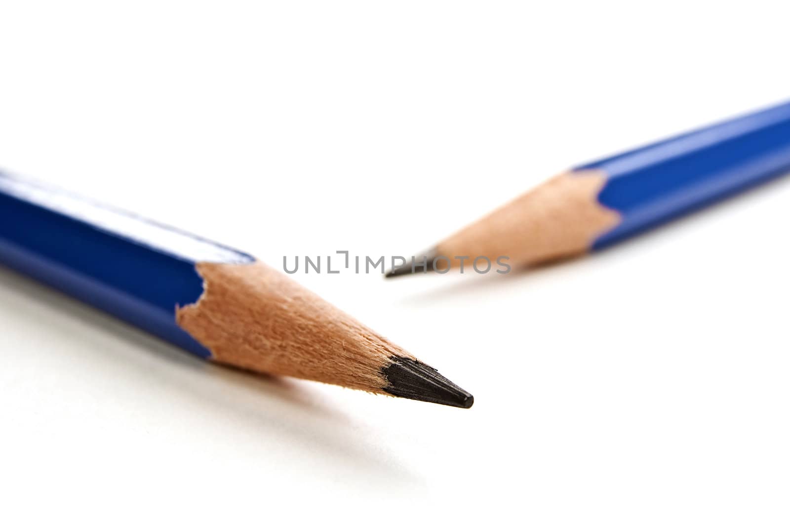 Sharp black pencils tips on white background.