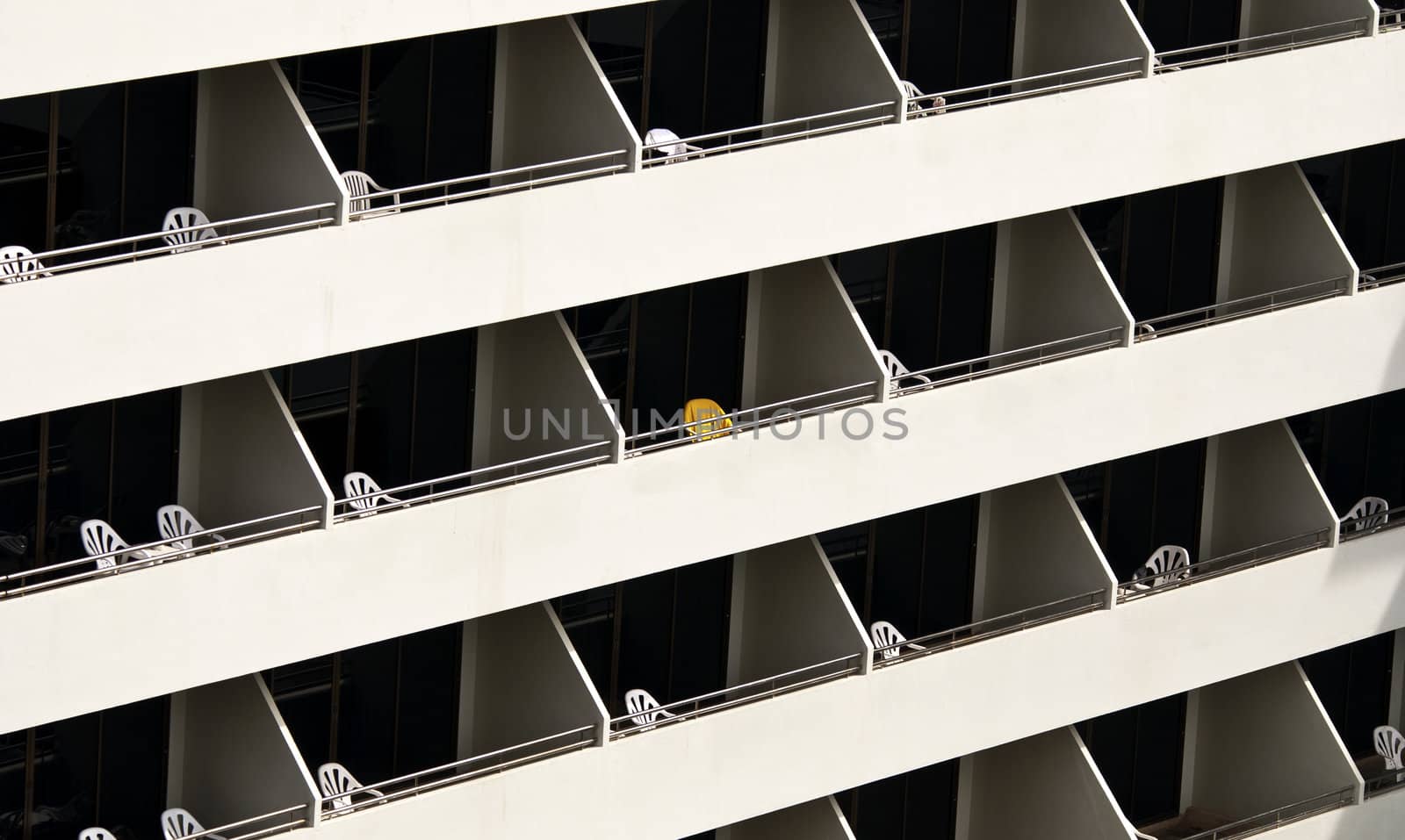 Hotel balconies with chairs on in the sun