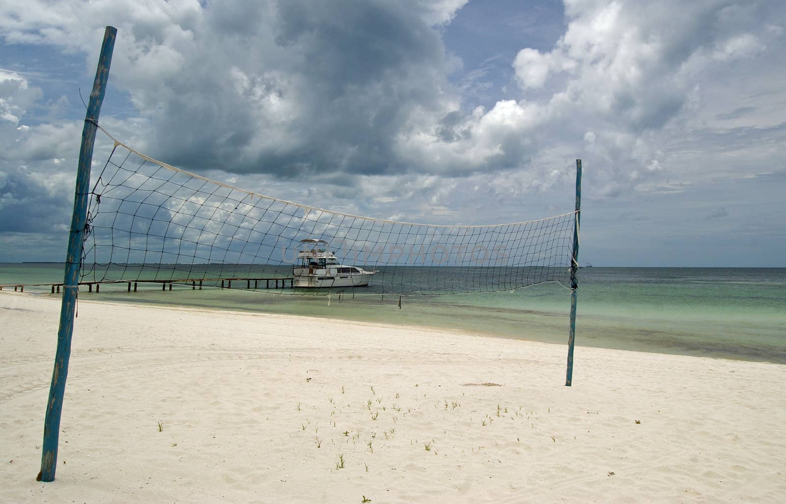 Volleyball net at beach by baggiovara