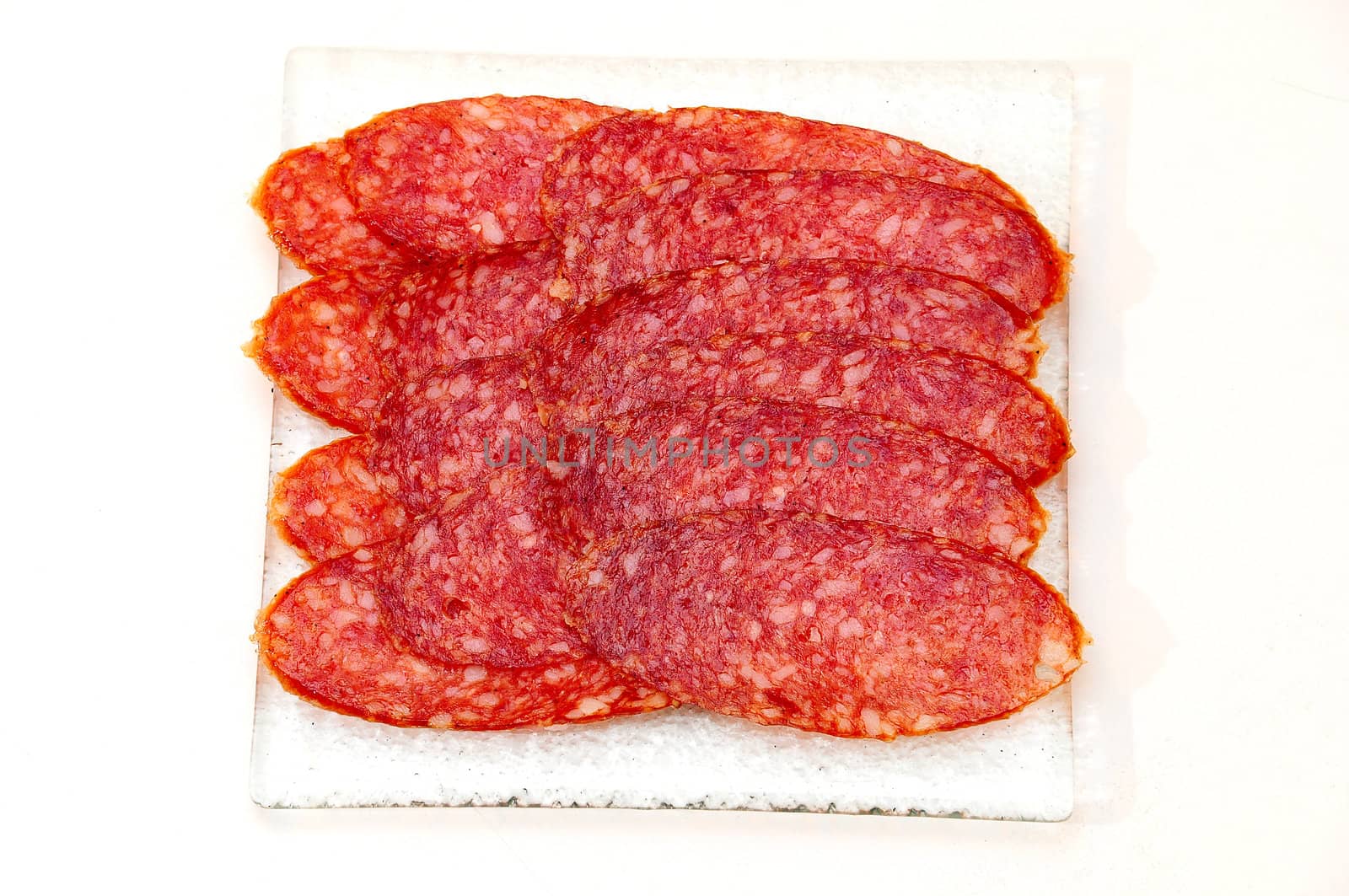 Salami  on the glass plate.