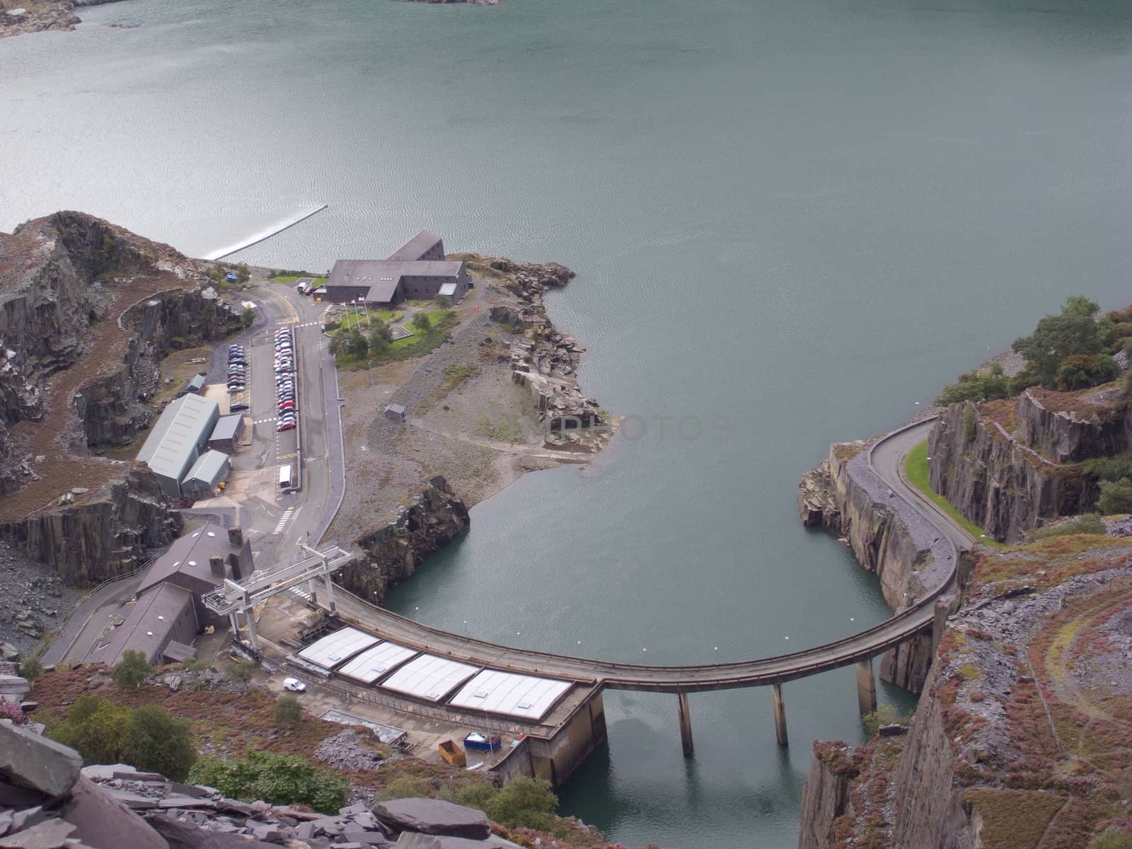 Hydro-electric power station buildings on the side of a lake.