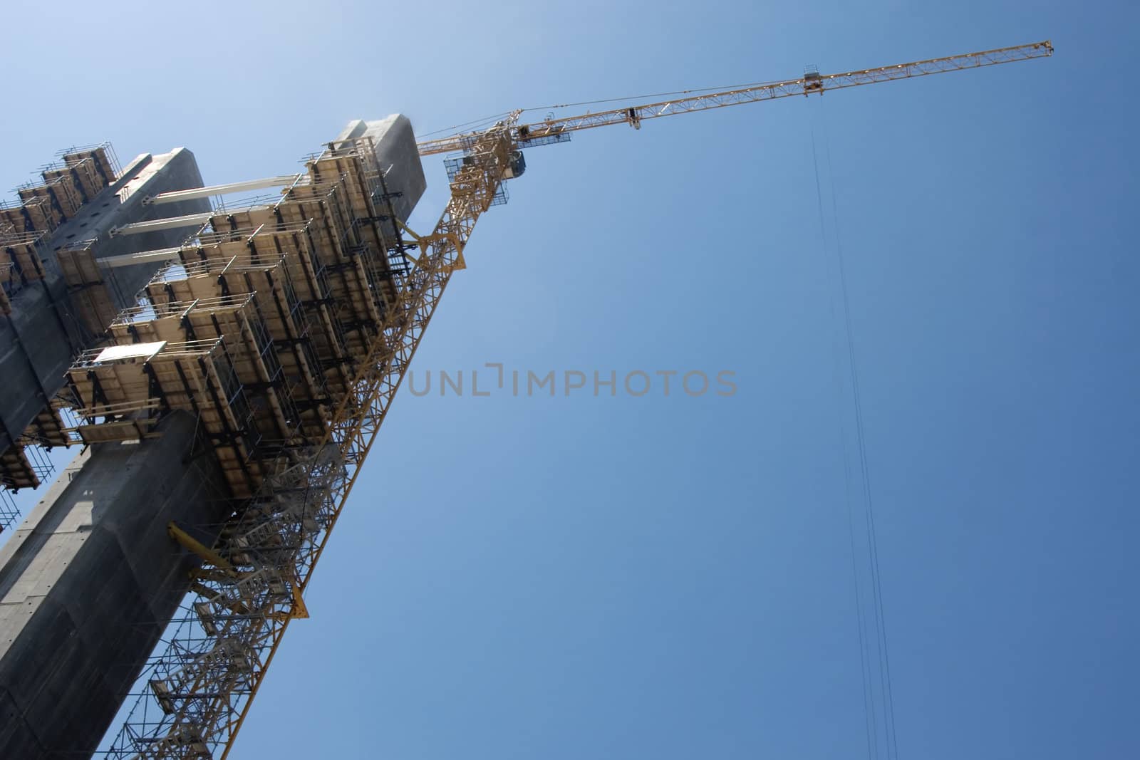 tower crane working on construction on blue sky background