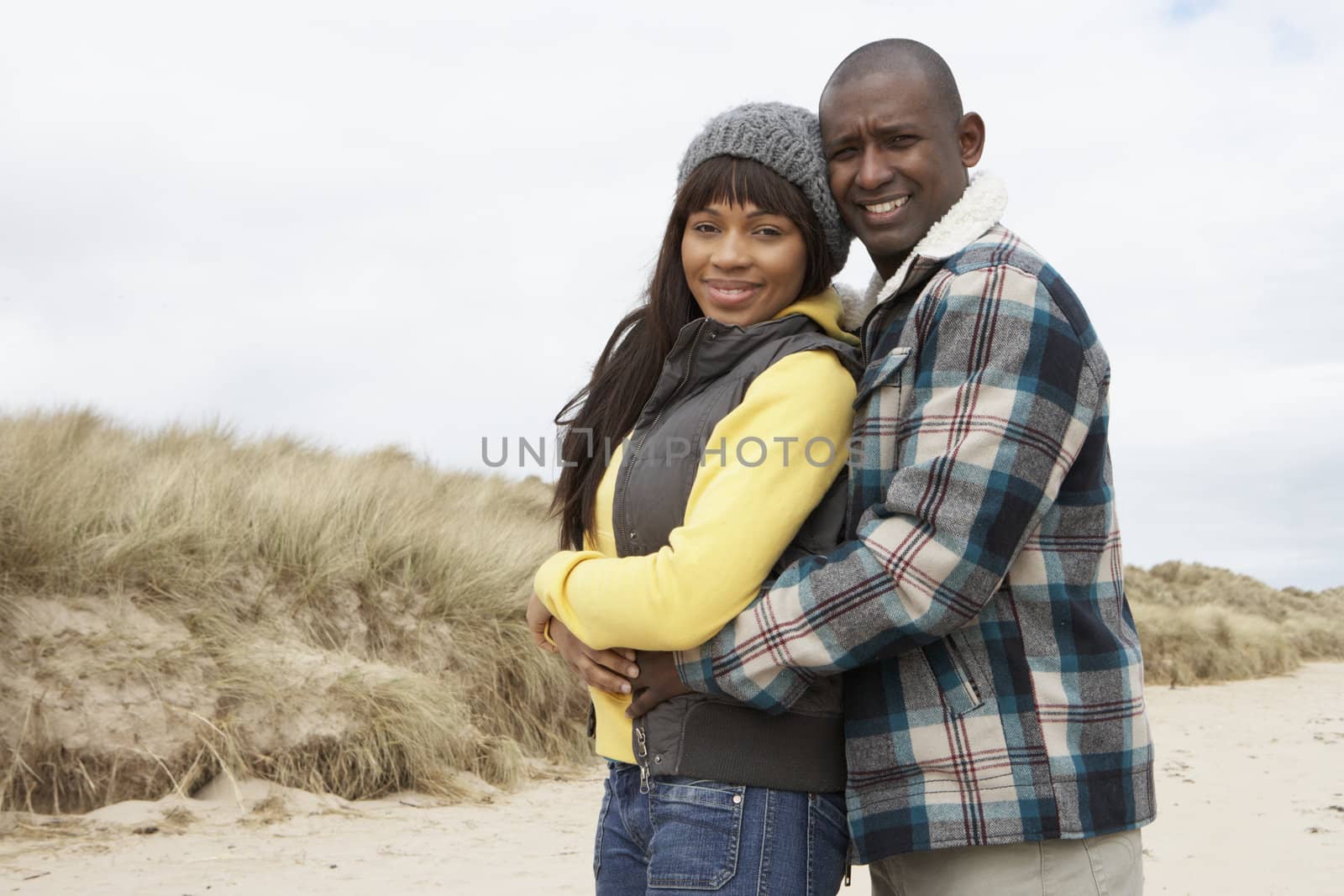 Romantic Young Couple On Winter Beach by omg_images