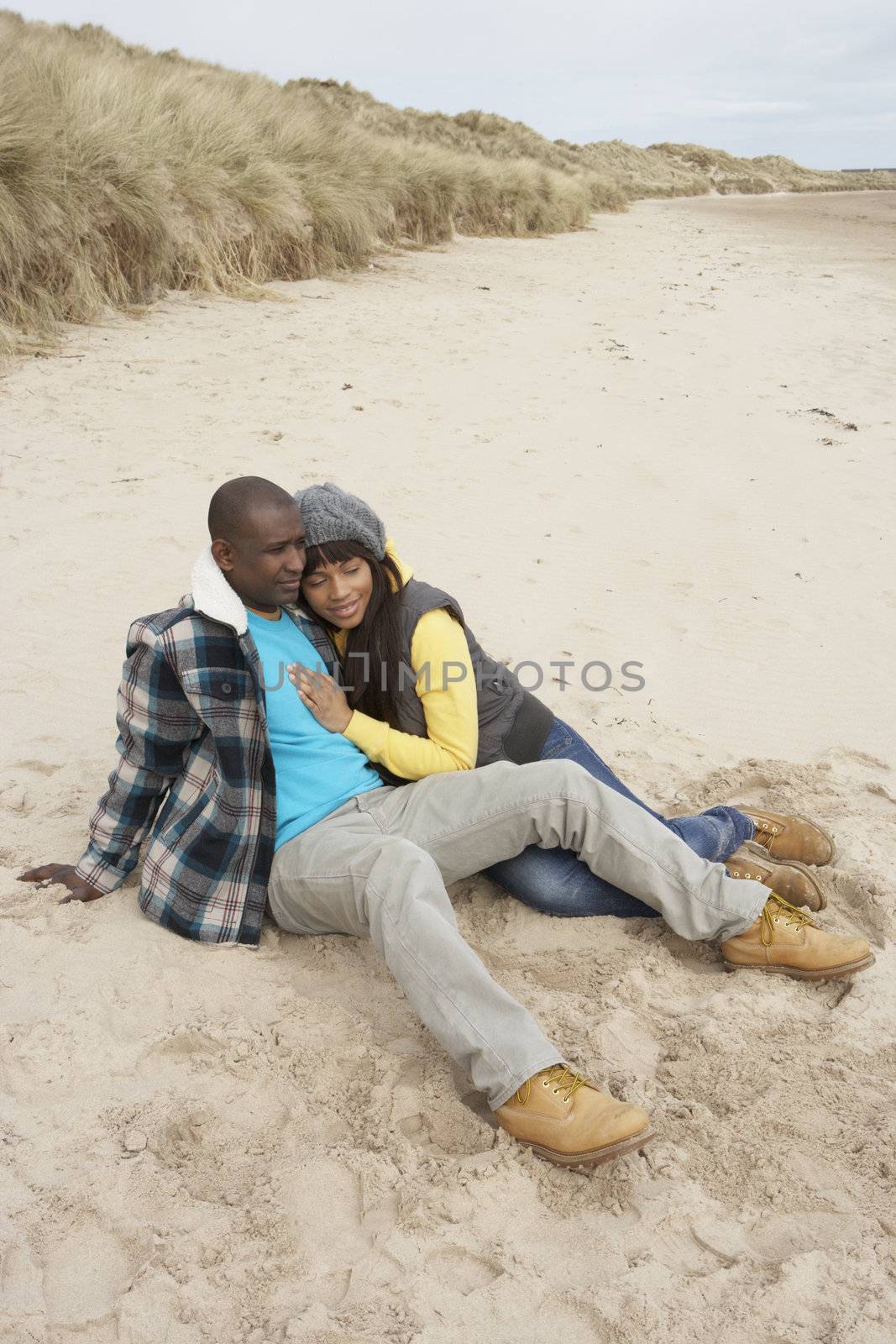 Romantic Young Couple On Winter Beach by omg_images