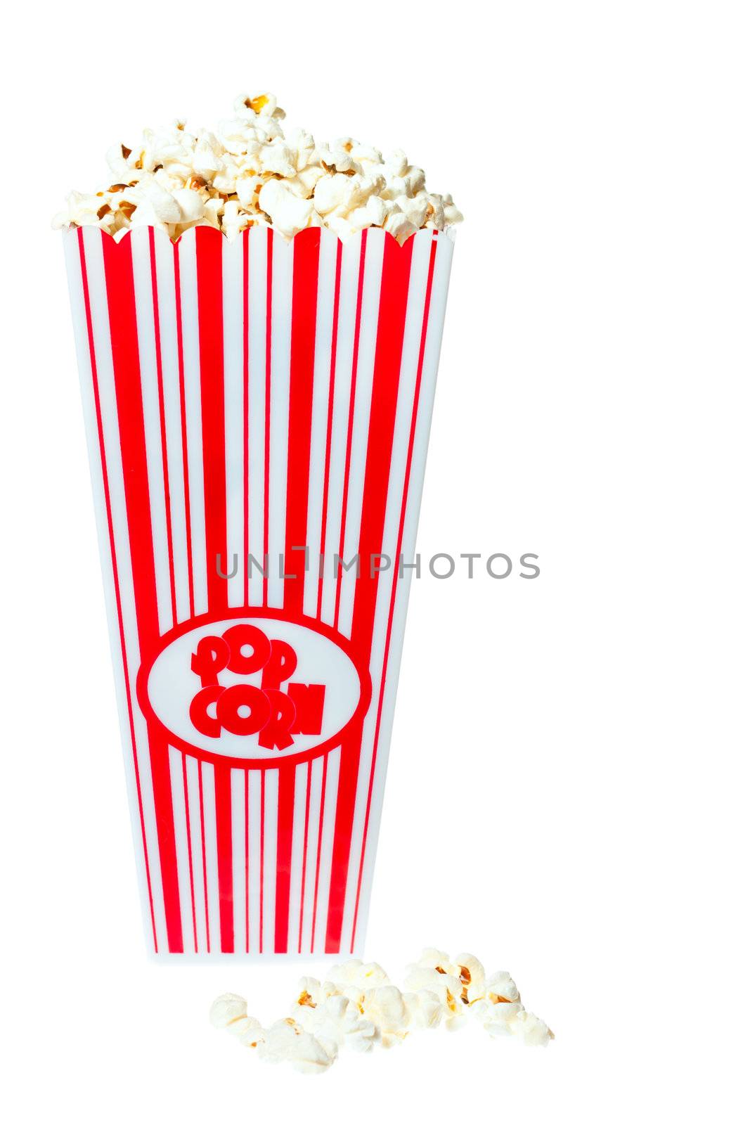 Popcorn tub overflowing with fresh delicious popcorn. Isolated on white