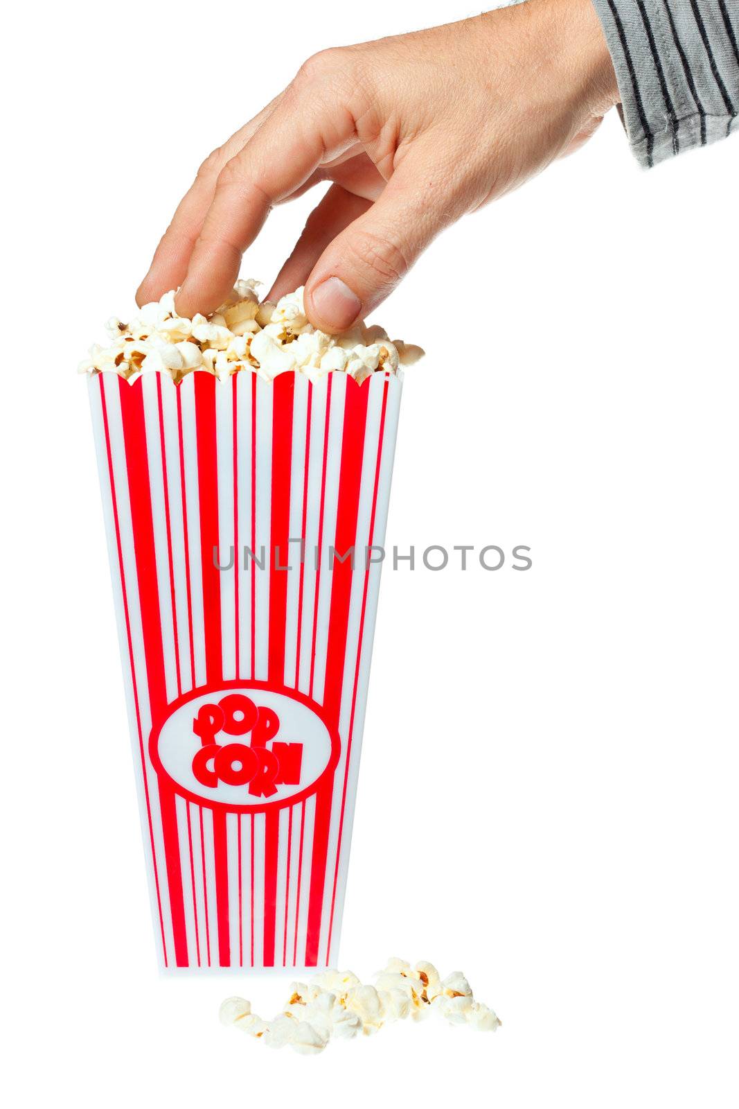 Hand grabbing popcorn out of container by Jaykayl