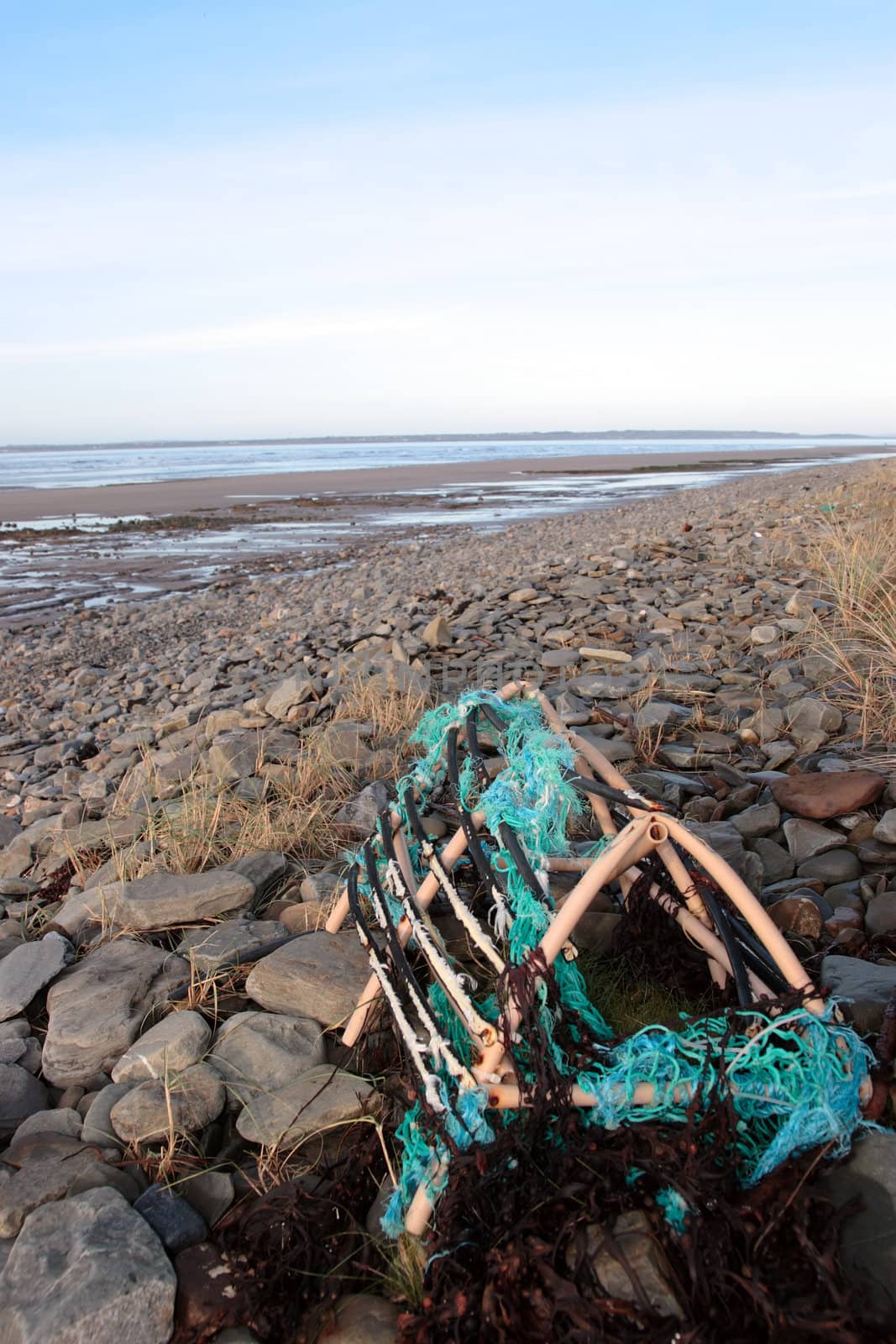a lobster pot on a rocky irish beach on the west coast