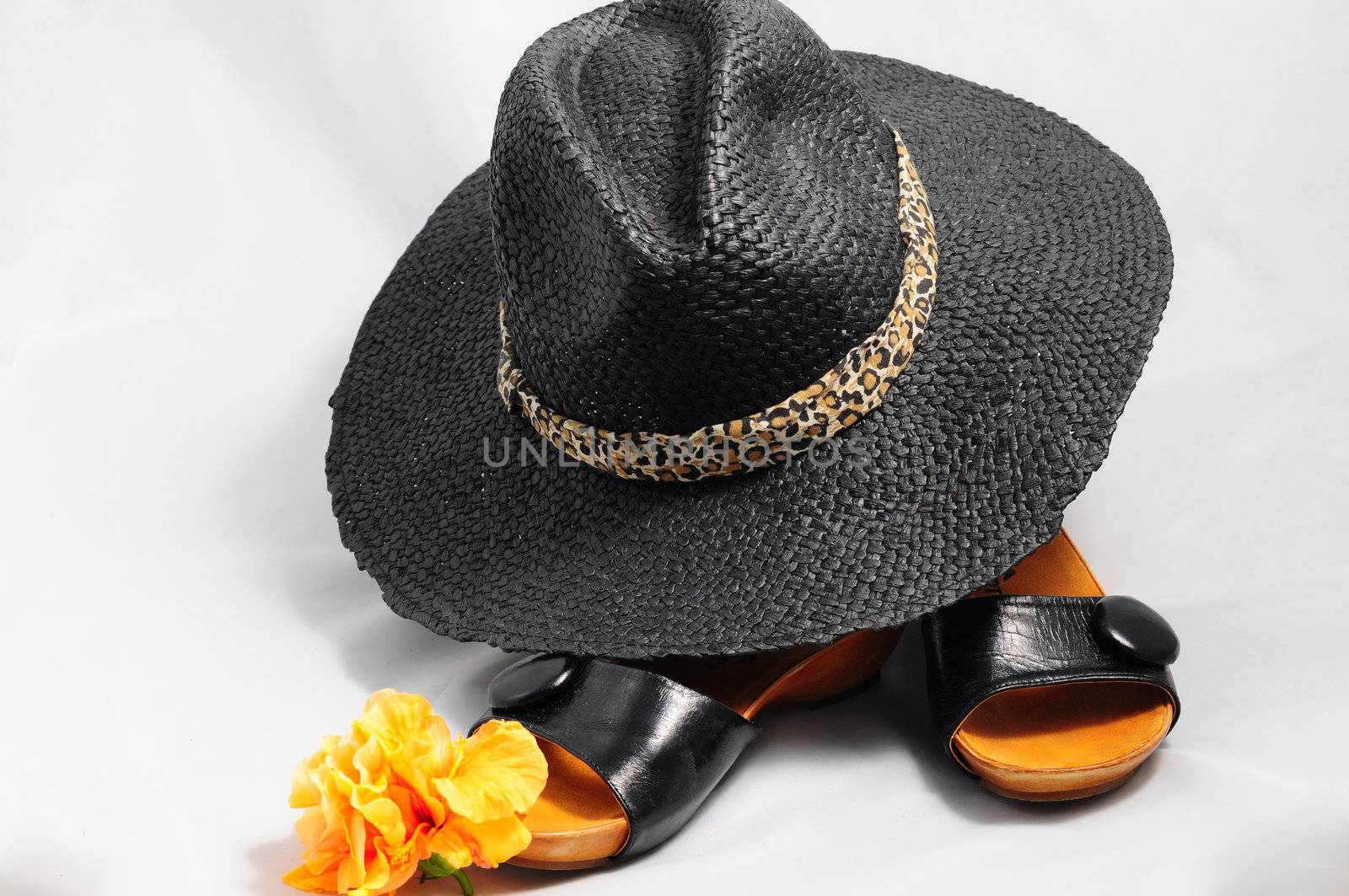 Ladies' black hat against the sun and black sandals.