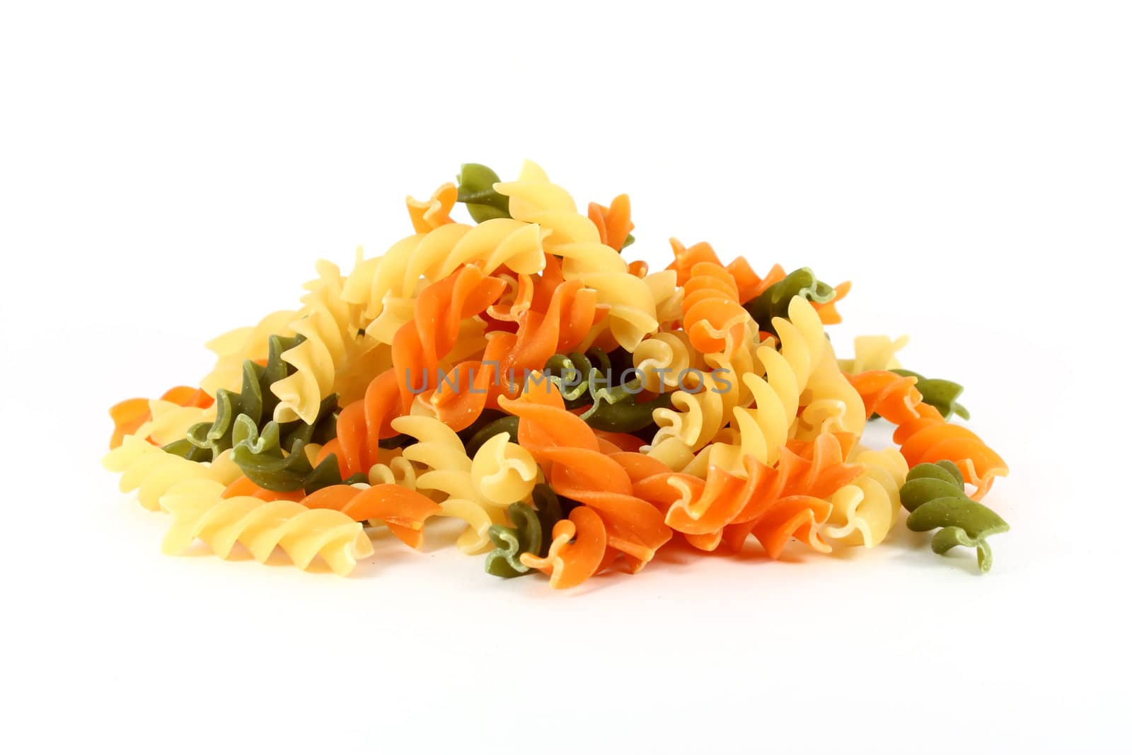 Raw colored pasta fusilli isolated on white background