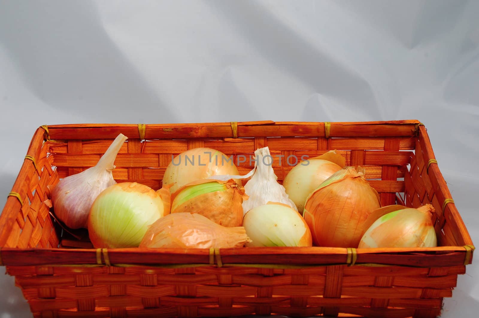 Brown onions in small basket .