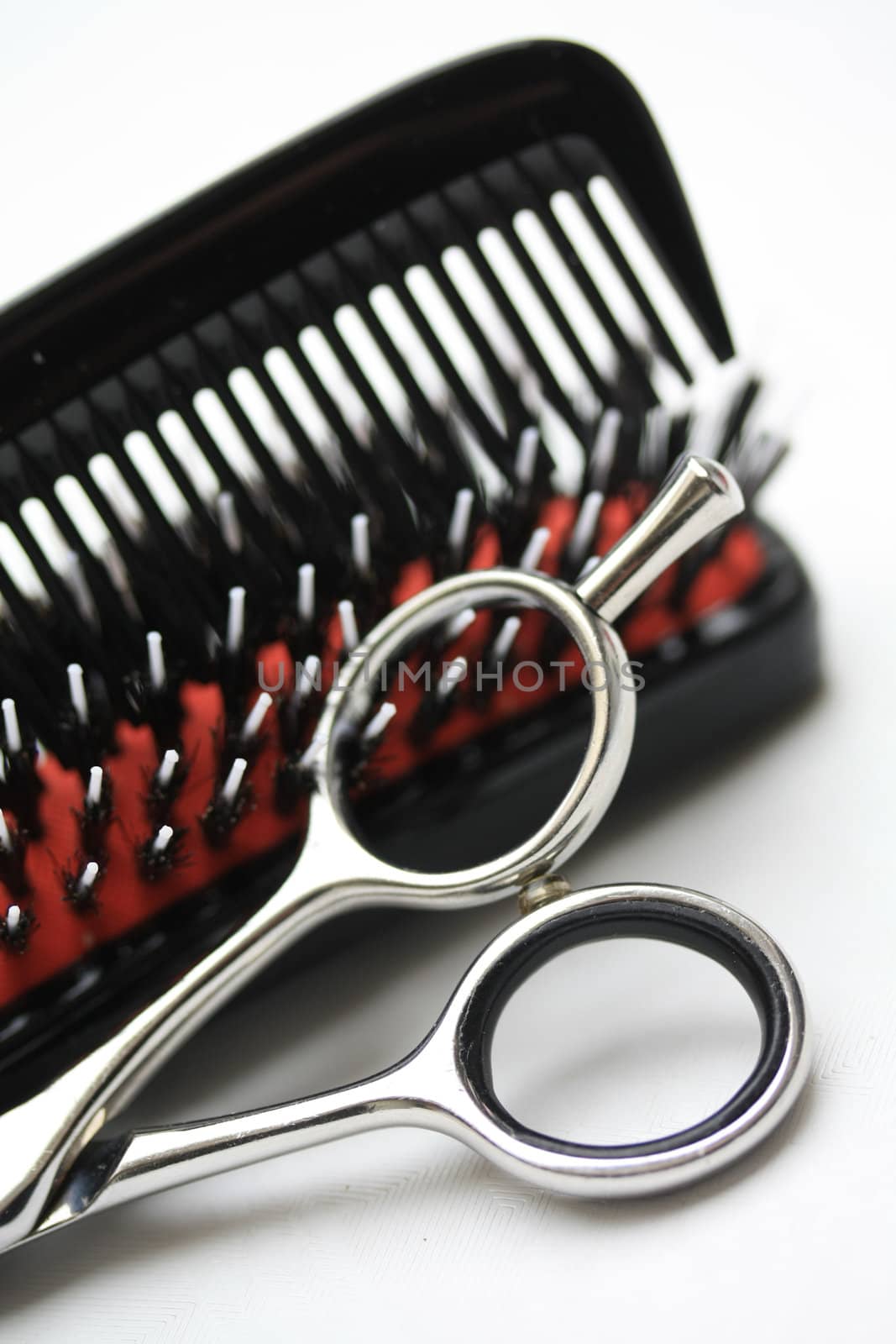 A pair of hairdressers scissors, a comb and a brush, the basic equipment for any hairdresser
