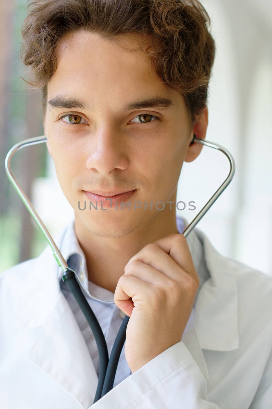 Close-up portrait of a smiling young doctor